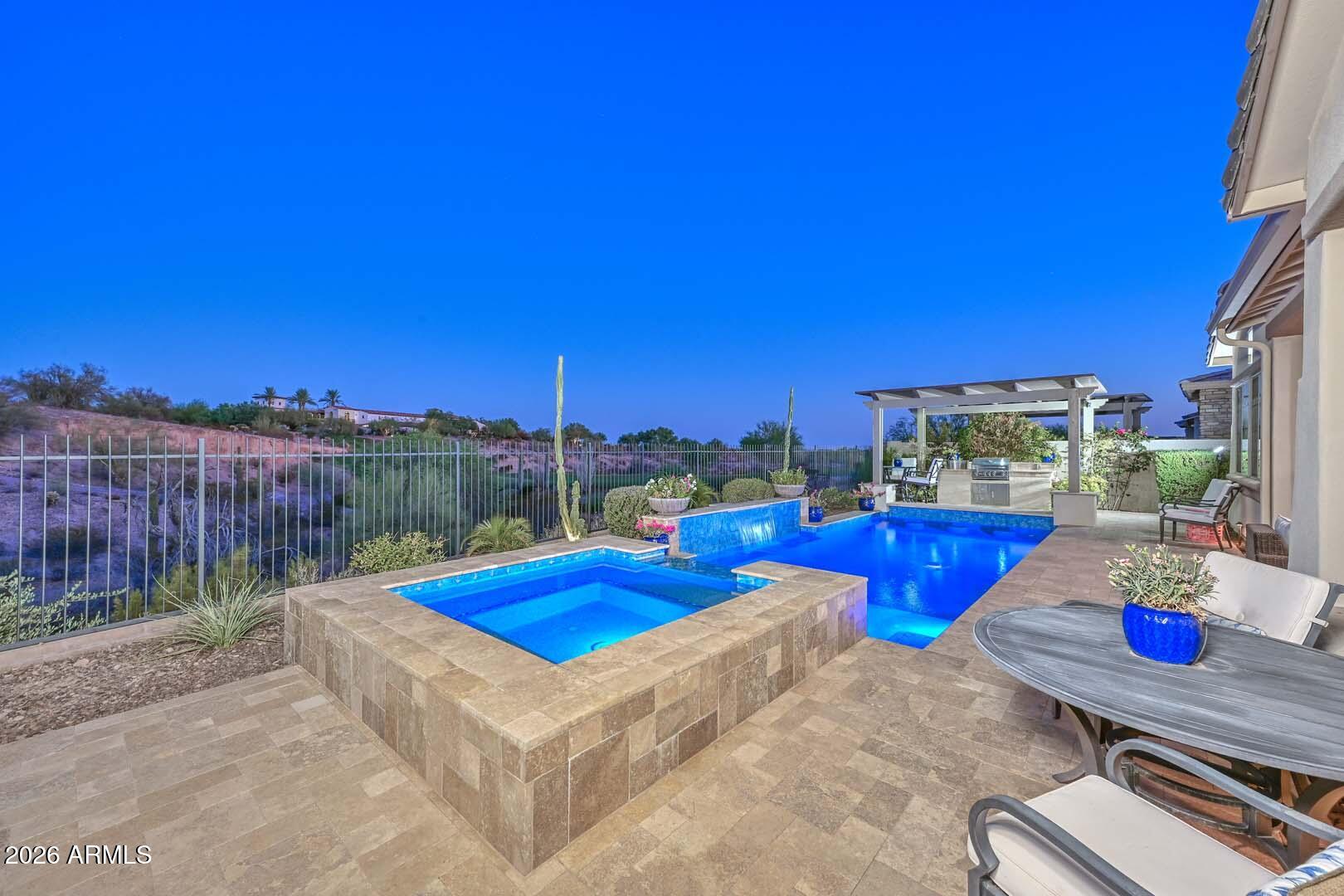 Perched on one of the most coveted homesites in the community, this stunning 3 bedroom, 3.5 bath Westland floor plan offers spectacular golf course views overlooking the signature 9th hole, along with a private heated pool and spa. Impeccably maintained and beautifully appointed, this home combines designer finishes with exceptional indoor-outdoor living.
Inside, you'll find gorgeous wood-look tile flooring throughout the main living areas, upgraded carpet in both guest en suites, and an open-concept design that lives like a model home. The gourmet kitchen is a true showpiece, featuring stacked cabinetry with glass display accents, granite slab countertops, full tile backsplash, under-cabinet lighting, and built-in stainless steel appliances, including a gas cooktop with double ovens. The expansive great room showcases a gas fireplace, dramatic raised ceilings with wood beam accents, and impressive 90-degree sliding glass doors that seamlessly connect the indoor living space to the backyard. Adjacent to the kitchen, the dining area is highlighted by custom lighting and a built-in buffet complete with a wine refrigerator.

Wake up to breathtaking golf course views from the luxurious primary suite, featuring custom barn doors, designer ceiling fan, electronic window shades, and a spa-inspired bath with a floor-to-ceiling tiled walk-in shower, rain shower head, dual vanities, and an impressive walk-in closet with custom mirror.

Step outside to your own private resort. The backyard is designed for entertaining with a heated pool and spa, swim-up bar seating, BBQ island beneath a pergola, and a spacious covered patio equipped with an electronic sun shade--perfect for enjoying Arizona's beautiful weather year-round.

Ideally located just moments from the world-class Blackstone Country Club, this exceptional home offers luxury, comfort, and one of the finest golf course settings in the neighborhood.