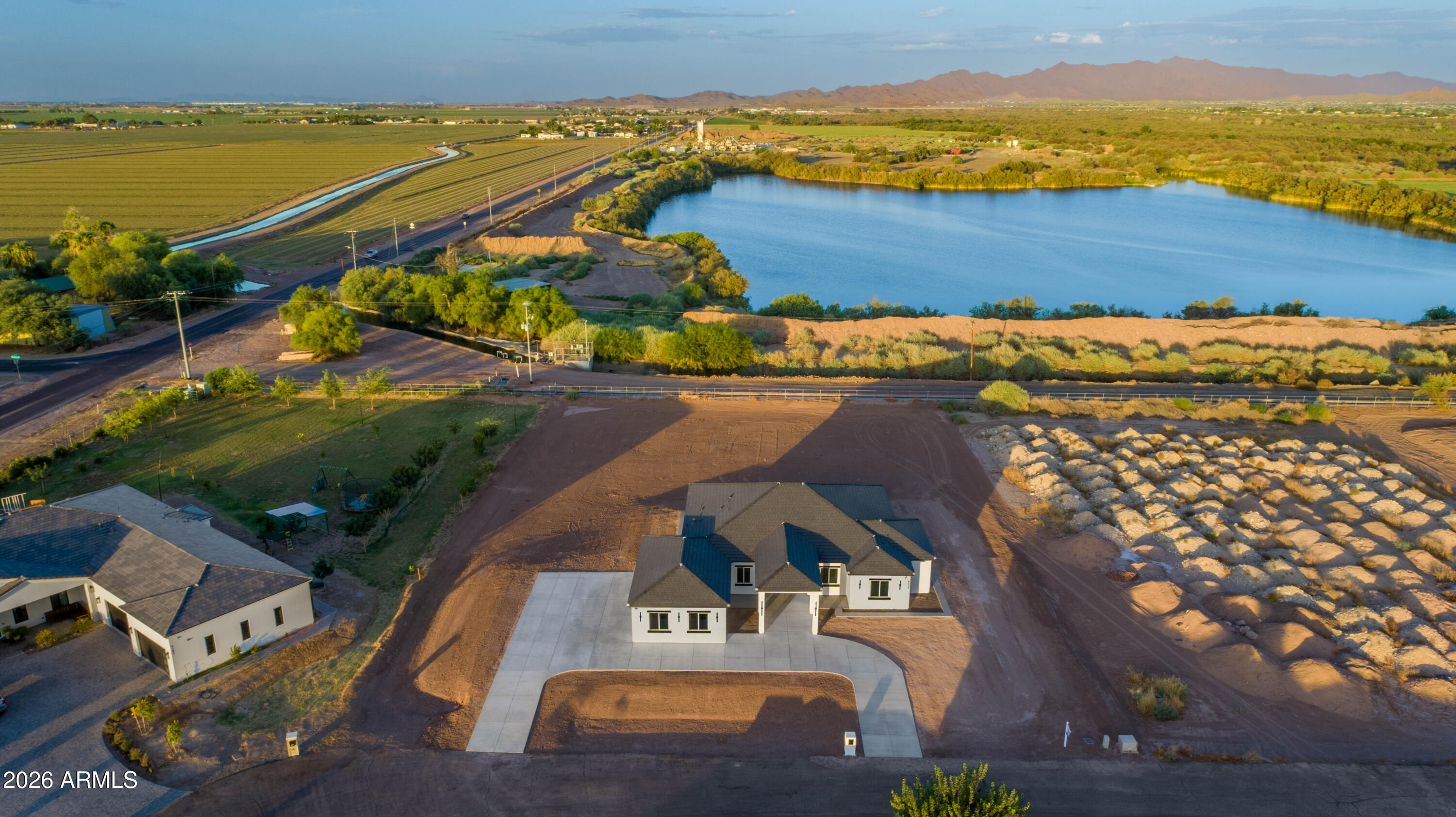 Experience refined living in this exceptional New 1 acre Custom Build modern residence, where sophisticated design meets effortless comfort--all set on a property with coveted horse privileges and valuable grandfathered irrigation rights, offering a rare blend of luxury and open lifestyle. Nestled in the highly sought-after White Fence Farms community, this stunning home combines the tranquility of estate living with the prestige of one of the area's most desirable neighborhoods.

This stunning home features 10 foot ceilings, 5 spacious bedrooms, 3 beautifully appointed bathrooms, and a versatile den or office, thoughtfully designed to accommodate both elevated everyday living and everyday functionality.

A grand entrance welcomes you with striking 8-foot double iron front doors, setting the tone for the upscale finishes found throughout. Expansive 24x48 polished porcelain tile flooring creates a seamless, contemporary aesthetic, while dramatic quartz countertops with a waterfall edge serve as a bold centerpiece in the heart of the home. 

The thoughtfully designed split-bedroom layout provides added privacy, with a spacious primary suite that offers comfort and functionality. The primary bathroom features a walk-in shower with a raindrop fixture, creating a clean, modern feel, and all bathrooms in the home feature walk-in showers.

Designed for modern living, the home is fully equipped with integrated technology, including a wired, subscription-free Reolink security camera system covering the entire exterior. Enjoy immersive entertainment with a 5.1 surround sound system and outdoor patio speakers already installed--perfect for hosting or relaxing outdoors. The home is also fully wired for high-speed internet, with service already available and ready for activation.

The entire 1-acre property has been professionally graded, providing a level, well-prepared canvas for your outdoor plans. The front yard is ready for your personal vision, with sleeves already installed beneath the surface for future irrigation and electrical, making landscape installation simple and efficient. To help bring your vision to life, with the right offer, the seller is offering a $10,000 sellers concession toward front landscaping, allowing you to create an outdoor design that reflects your own vision.  

For added convenience, the property includes a Tesla wall charger, compatible with Tesla vehicles and other J1772-capable electric vehicles (adapter sold separately). Enhancing both value and usability, the home also includes grandfathered irrigation rights--an increasingly rare and desirable benefit. With its unique combination of luxury finishes, advanced technology, horse privileges, professionally graded acreage, no rear neighbors, this property offers an exceptional opportunity to enjoy both refined living and wide-open possibilities.
