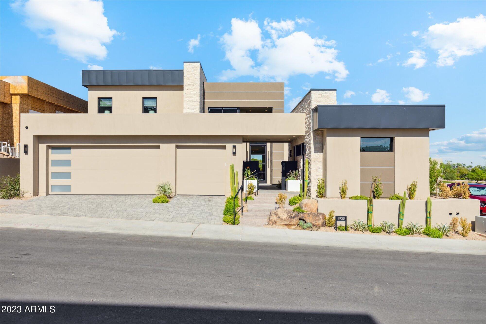 Custom designed to-be built home by Cullum Homes, this contemporary, fully furnished residence overlooks the 9th hole of the Phoenician Golf Course and sits on the base of Camelback Mountain on the grounds of the iconic Phoenician.
As you enter this lock-and-leave home, a charming courtyard with a fountain welcomes you toward the guest casita and the impressive 20-foot glass entry door. The casita is ideal for guests or a home office and includes a kitchenette, full bath, and built-in file cabinets.
Inside the main house, a large foyer and warm wood flooring lead your eye through the dining room and great room to the lush green of the golf course. Just off the entry is an office with built-in cabinetry and a private outdoor patio. The great room flows seamlessly into the chef's kitchen, adorned with Sub-Zero, Wolf, and Cove appliances, as well as a built-in wine cabinetproviding everything needed for effortless entertaining. The entire back of the home opens onto a spacious patio overlooking the course. A water feature, large spa, built-in BBQ, and full landscaping complete this impressive outdoor living space.
The primary suite offers a bespoke fireplace, views of the green, and direct access to the back patio. The spa-like primary bath features a freestanding tub, walk-in shower, dual sinks, and a custom closet.
Guests may take the elevator or staircase to the second floor. The loft, complete with a full wet bar, opens to a 560-sq-ft deck with a fireplace and sweeping views of the 9th hole, Camelback Mountain, and the sparkling lights of downtown Scottsdale. This vantage point is truly unbeatable. Two spacious ensuite guest rooms, one with direct access to the upper deck, complete the upper level.

An insulated garage provides ample space, including room for a golf cart to easily explore the Phoenician grounds. This is a true luxury lock-and-leave home.