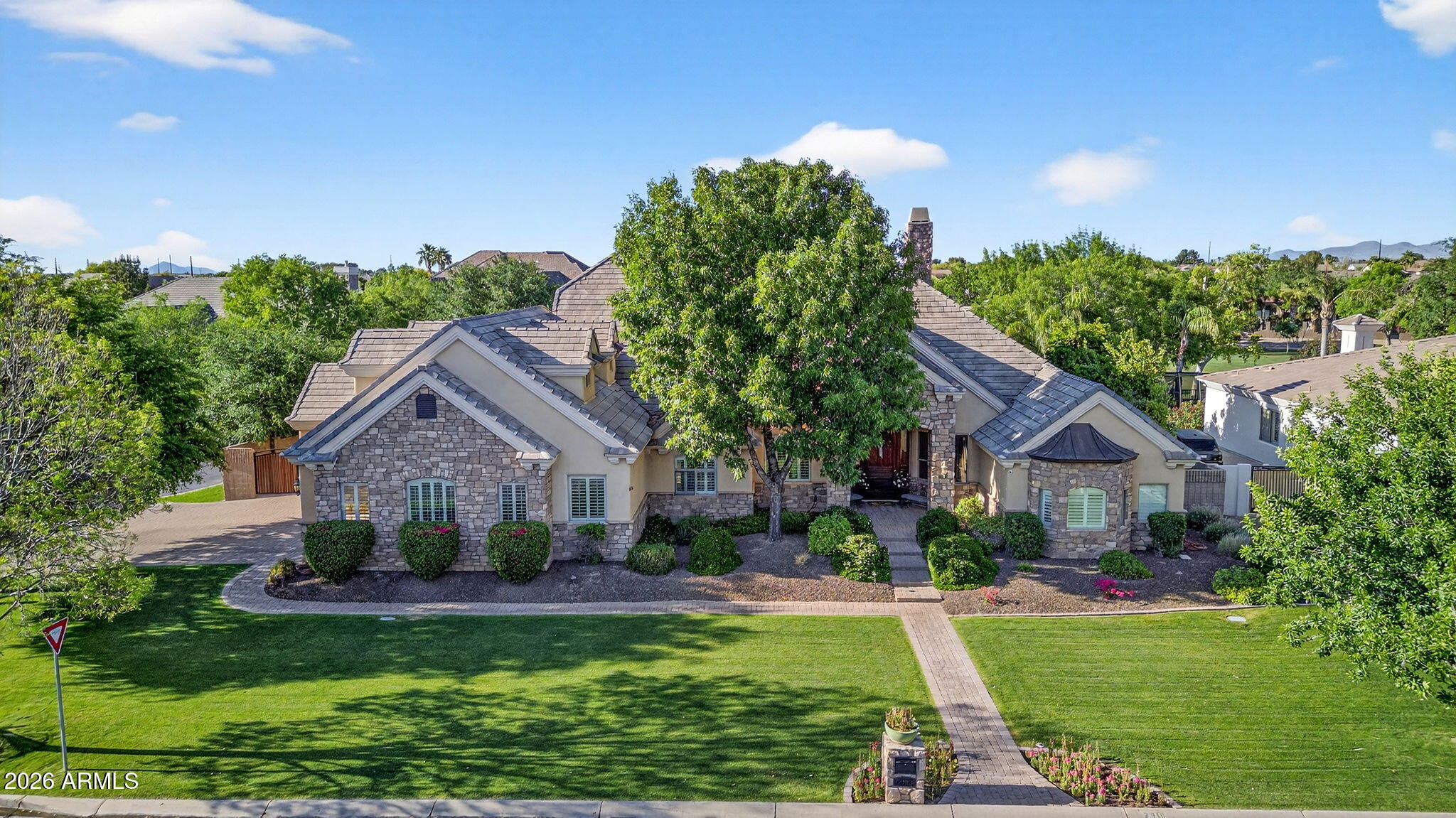 Welcome to  Whitewing -- Gilbert's Most Coveted Address

Nestled on a premier corner lot in the prestigious Whitewing Gated Community, this extraordinary estate is a rare offering that hasn't graced the market in over two decades. With 8 bedrooms, 5.5 bathrooms, and a thoughtfully designed layout spanning multiple levels, this is the definition of elevated Arizona living.

A comprehensive 2021 remodel by AFT Construction has elevated every surface and space -- from updated flooring, chef-inspired kitchen, modern bathrooms, and bespoke crown molding to coffered ceilings  -- reflecting a level of craftsmanship seldom found in today's market. At the heart of the home, the chef's kitchen is nothing short of exceptional. Monogram stainless steel appliances, a gas cooktop, a built-in refrigerator, double ovens, a built-in ice maker, and a commanding quartz island anchor a space designed for both intimate family mornings and grand-scale entertaining. The butler's pantry and dining nook with a bay window complete the picture.

The primary suite is a private sanctuary -- a fireplace, sitting area, patio access, and a spa-inspired bath featuring a jetted soaking tub, steam shower, dual vanities, a fully automated Toto bidet toilet, and two walk-in closets.

The versatile layout accommodates every lifestyle: a den with a built-in bookcase, a finished basement with 4 bedrooms, 2 baths, and game and living areas, plus a private bonus suite above the garage -- ideal for multigenerational living, guests, or a secluded home office.

Step outside to a backyard that rivals a private resort: a heated diving pool with baja step, a water feature, and a built-in spa; a covered patio with tongue-and-groove ceilings; sport court; RV gate; and direct access to the community park with pickleball, a playground with a massive new shade structure and 6.5  acres of maintained green space -- none of which falls on you to upkeep.

Garage finished with epoxy floors, central vacuum, insulated garage doors, and extended-length bays, plus 240 amp charging port for electric vehicles or RV's,  and Insta-Hot system for hot water on demand; every detail has been considered.

Homes of this caliber, in this community, simply do not come available. This is your moment.