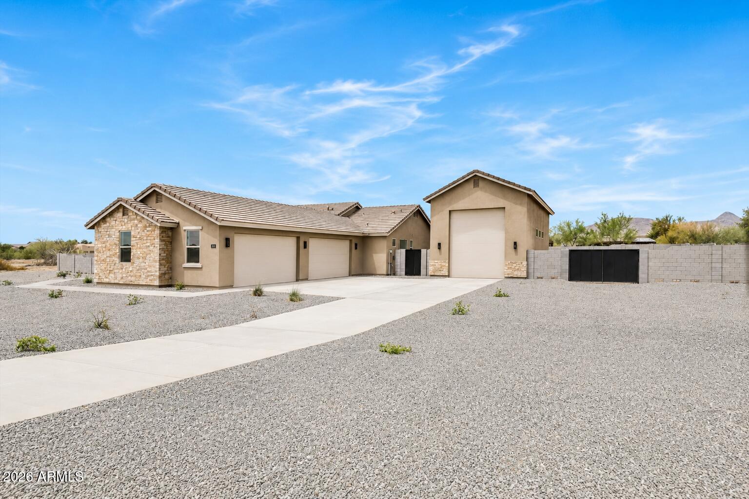 JUST COMPLETED brand new custom home featuring jaw-dropping finishes and a MASSIVE detached 20 X 50 RV garage. Listing updated with ACTUAL photos! Perched on a 1-acre lot with full block fencing, full front yard landscaping, no HOA, and breathtaking views of Cave Creek Peak and Pyramid Peak, this property truly stands apart. Inside, the gourmet kitchen impresses with upgraded cabinetry, quartz countertops, a massive center island, and a walk-in pantry. The spacious great room showcases a dramatic sliding glass door that opens to the outdoors and a beautiful chandelier centerpiece. Luxury continues throughout the home with wide-plank wood like tile flooring, a freestanding soaking tub in the owner's suite, and so much more!