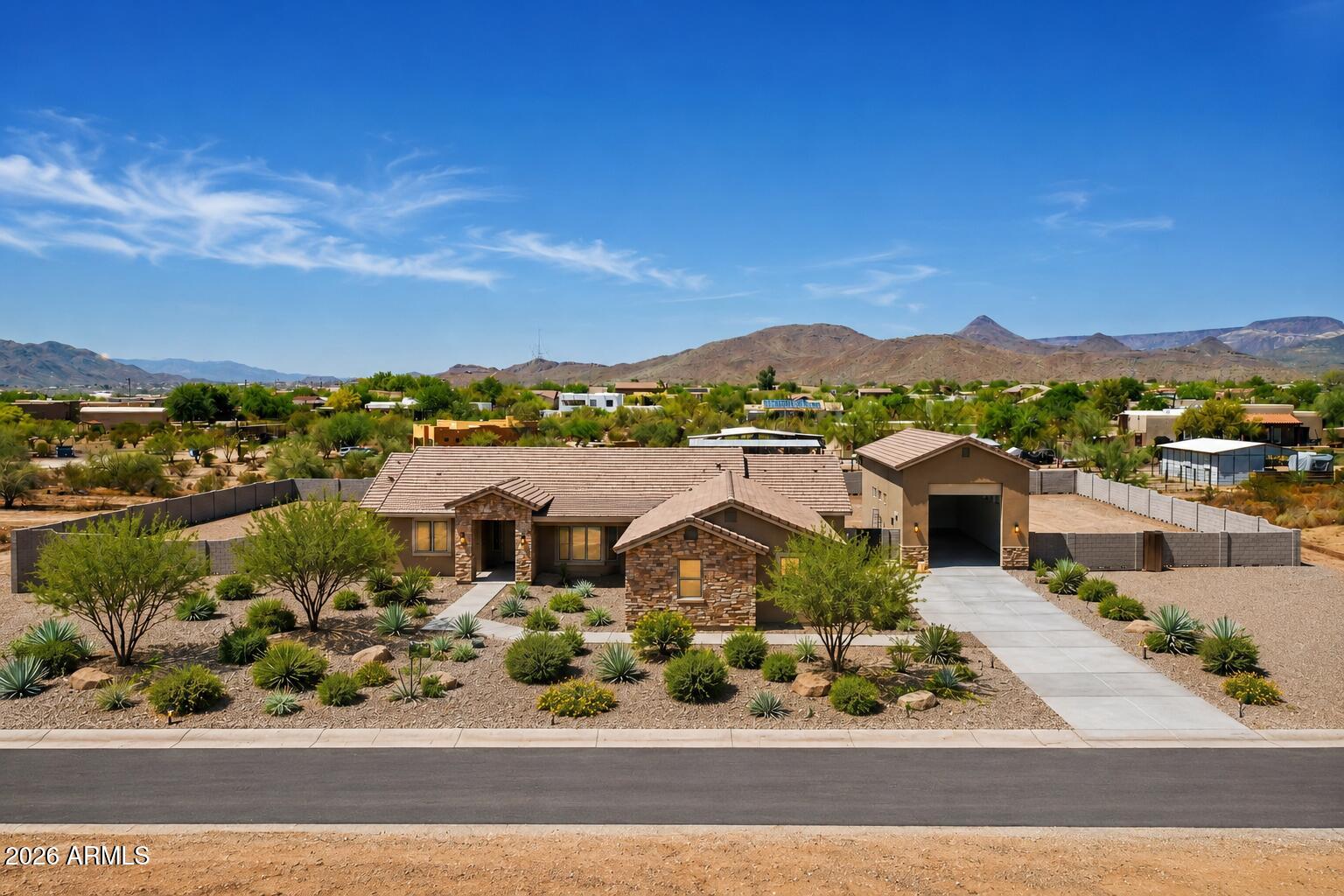 JUST COMPLETED brand new custom home featuring jaw-dropping finishes and a MASSIVE detached 20 X 50 RV garage. Perched on a 1-acre lot with full block fencing, full front yard landscaping, no HOA, and breathtaking views of Cave Creek Peak and Pyramid Peak, this property truly stands apart. Inside, the gourmet kitchen impresses with upgraded cabinetry, quartz countertops, a massive center island, and a walk-in pantry. The spacious great room showcases a dramatic sliding glass door that opens to the outdoors and a beautiful chandelier centerpiece. Luxury continues throughout the home with wide-plank wood like tile flooring, a freestanding soaking tub in the owner's suite, and so much more! Front yard landscaping is included, and will be installed by June 12th.