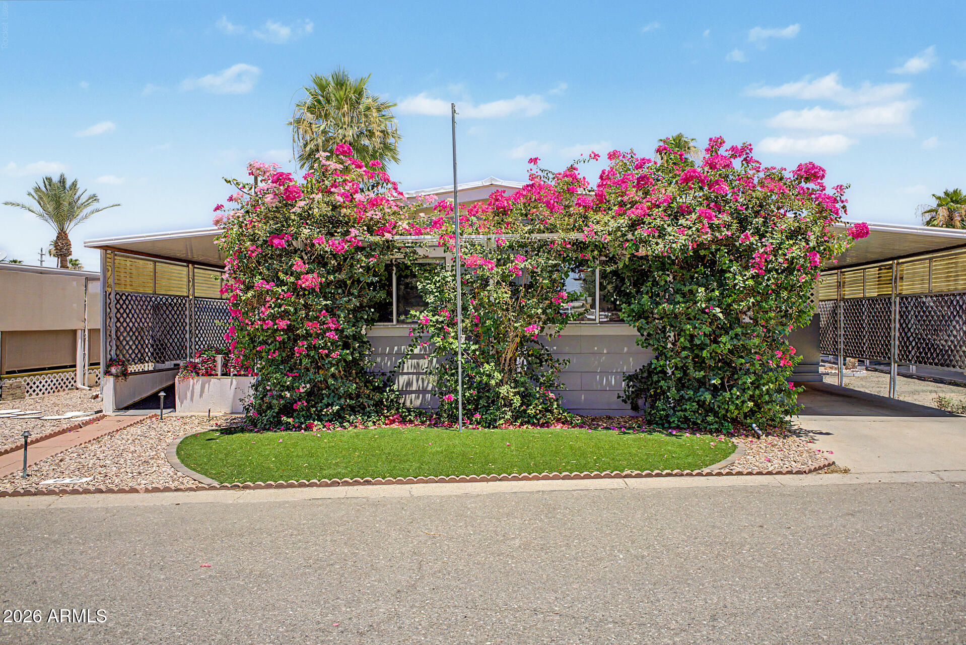 This beautiful, fully remodeled home, is located in a gated and private 55+ community with a pool and clubhouse. With over $53,000 in upgrades including NEW KITCHEN APPLIANCES, NEW A/C, NEW HOT WATER HEATER and THE MOST LUSH GARDEN OASIS this home is a must see! The home features new LG appliances including a three-door refrigerator, 5 Burner stove and oven with air fryer setting, over the counter microwave and dishwasher. The kitchen has ample storage, new counters, new tile, new garbage disposal and large pantry. A nice bonus room directly off of the large living room can be converted to an additional bedroom. Both bathrooms have been fully remodeled with new tile, Glacier Bay toilets, Jacuzzi brand shower enclosures and ceiling exhaust fan. (please see more...) The guest bedroom has been extended and feature a spacious office area. The master bedroom is large with a walk-in closet. The entire home includes new flooring throughout. All exterior walls include new drywall and exterior siding for added insulation and sound-proofing. A 13 cubic foot HVAC unit was installed by Parker & Sons in 2023 and comes with a 15 year warranty. A new hot water heater was installed in August 2024. An entirely new and upgraded electrical panel with all new breakers and wiring was installed in February. Well over $50,000 in upgrades with full warranties on all the appliances, HVAC, electrical panel, roof and shower enclosures. On the exterior, the home features two covered decks with one fully screened for privacy and comfort. The large rear yard is fully landscaped and has a relaxing paved patio with pergola and fountain which provides the perfect sitting area for morning coffee or evening dinners. A separate BBQ area with a covered pergola further sets this home apart from the rest.  Five arbors surround the rear yard providing shade and additional privacy. There are three large sheds which provide ample storage. A complete automated irrigation system and automatic landscape lighting make the yard a maintenance free retreat unlike anything else offered in the area. A complete security system is included with six cameras. This is a one-of-a-kind move-in ready home that is being offered $30,000 below the market value. TOTAL SQUARE FOOTAGE OF THIS MARVELOUS HOME IS 1376 SQUARE FEET.

The following is a detailed list of all improvements to home:
Air conditioning unit w/warranty $13,000.00
Hot water heater. $180.00
Refrigerator w/warranty $1100.00
Stove/oven w/warranty $800.00
Microwave w/warranty $400.00
Dishwasher w/warranty $400.00
Room addition $11,000.00
(2) Shower enclosures w/warranty $9,000.00
Completely landscaped yard front/back including perimeter fence and gate, (6) arbors, paved patio, paved BBQ area, large 12x14 patio cover, landscape lighting front/back, automatic irrigation front/back, artificial turf front/back $7,000.00
Exterior siding $4,000.00
Fresh paint $2,000.00
Laminate flooring throughout $1,800.00
Drywall in bedroom, bathrooms, living room and dining room $1,500.00
New electrical panel and breakers $3,500.00

Total upgrades and improvements $53,680.00
