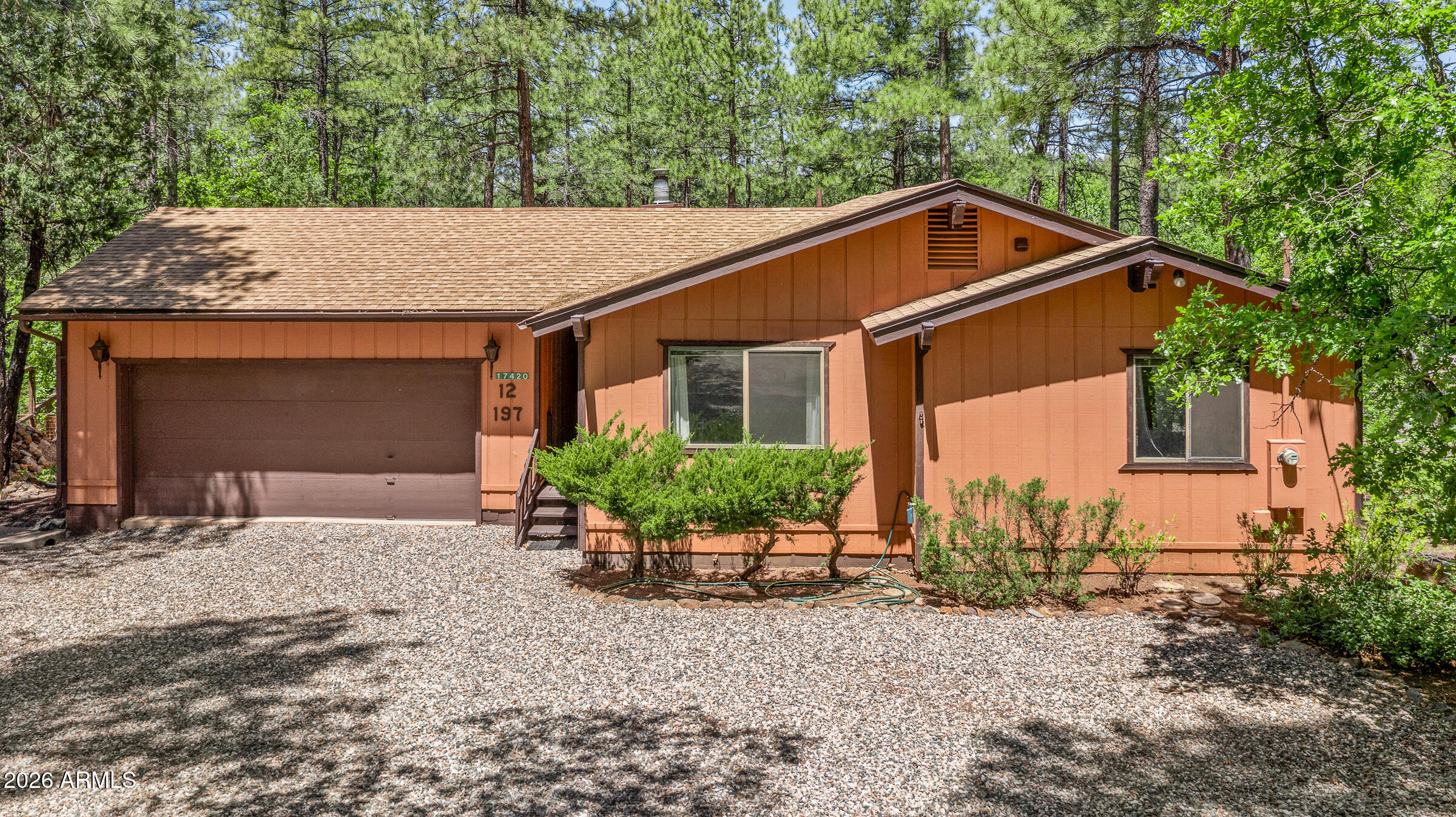 LOCATION, LOCATION, LOCATION - cozy 3-bedroom, 2-bathroom cabin with 2 car garage located on one of the best lots in Munds Park.  Wonderful small-town charm in the pines, with Coconino National Forest access only a half mile away, and Pinewood  Country Club right down the street (membership required).  Only 20 minutes from Flagstaff.  The property is located on the locally known 'Animal Hill' and backs Munds Canyon - no neighbors behind you, only trees and sky!   This lot is 1/3 acre, double the size of most Munds Park interior lots!  Has a large covered rear wrap around deck and large usable backyard!   Well maintained and turnkey ready!