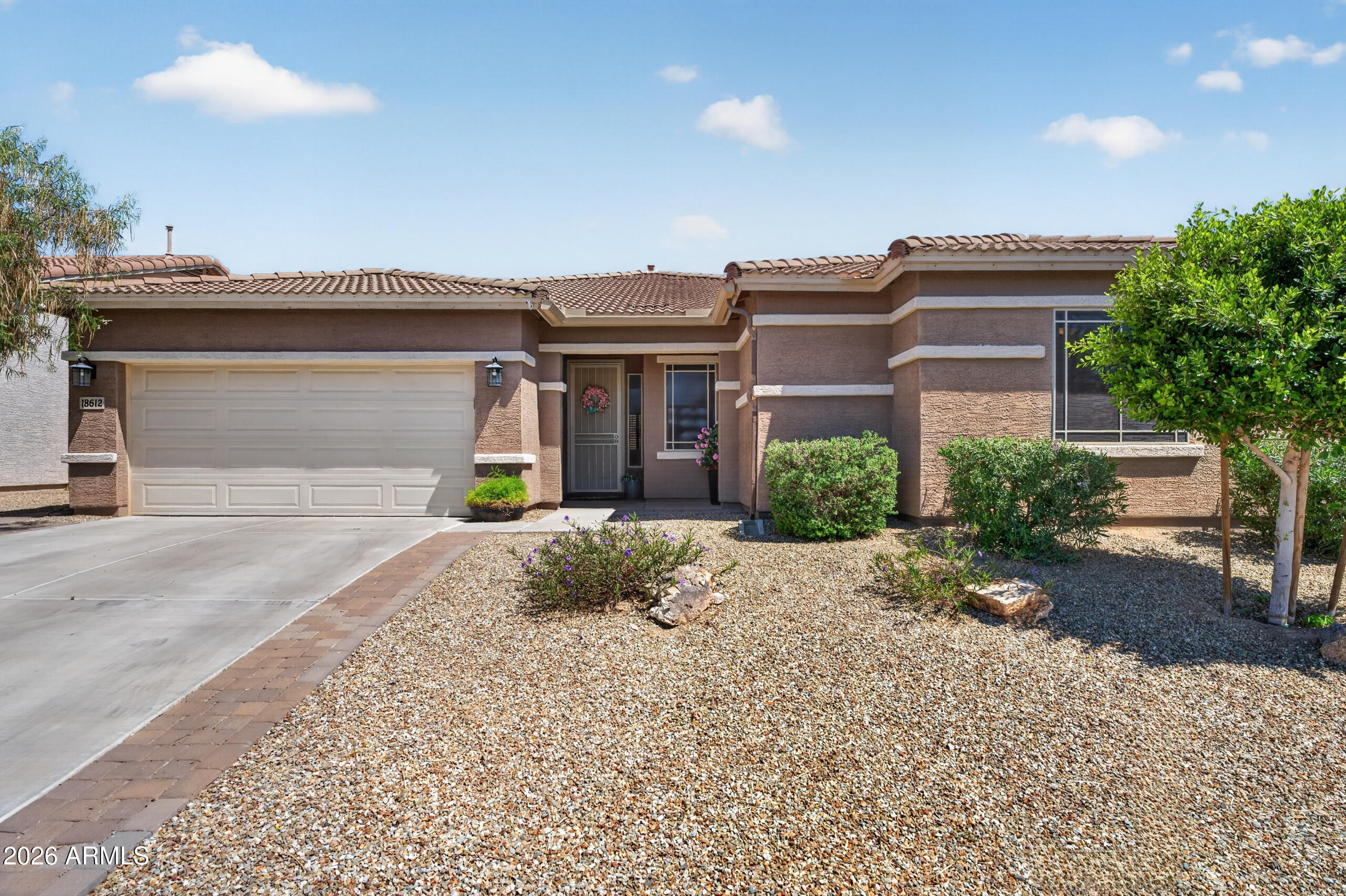 This home showcases true pride of ownership throughout, shows like a model. Featuring 4 bedrooms and 2.5 baths for all your needs. Enjoy tile and luxury plank flooring throughout, complemented by crown molding. The spacious kitchen flows into a great room with double sliding door and an additional family room with triple pane sliding door for lots of light and that indoor - outdoor living. Tastefully designed backyard with low maintenance turf, plenty of pavers and a gazebo added for shade and relaxation. Located in a master-planned community centered on its family-friendly amenities. Located just minutes from White Tank Mountain Regional Park and White tank library.