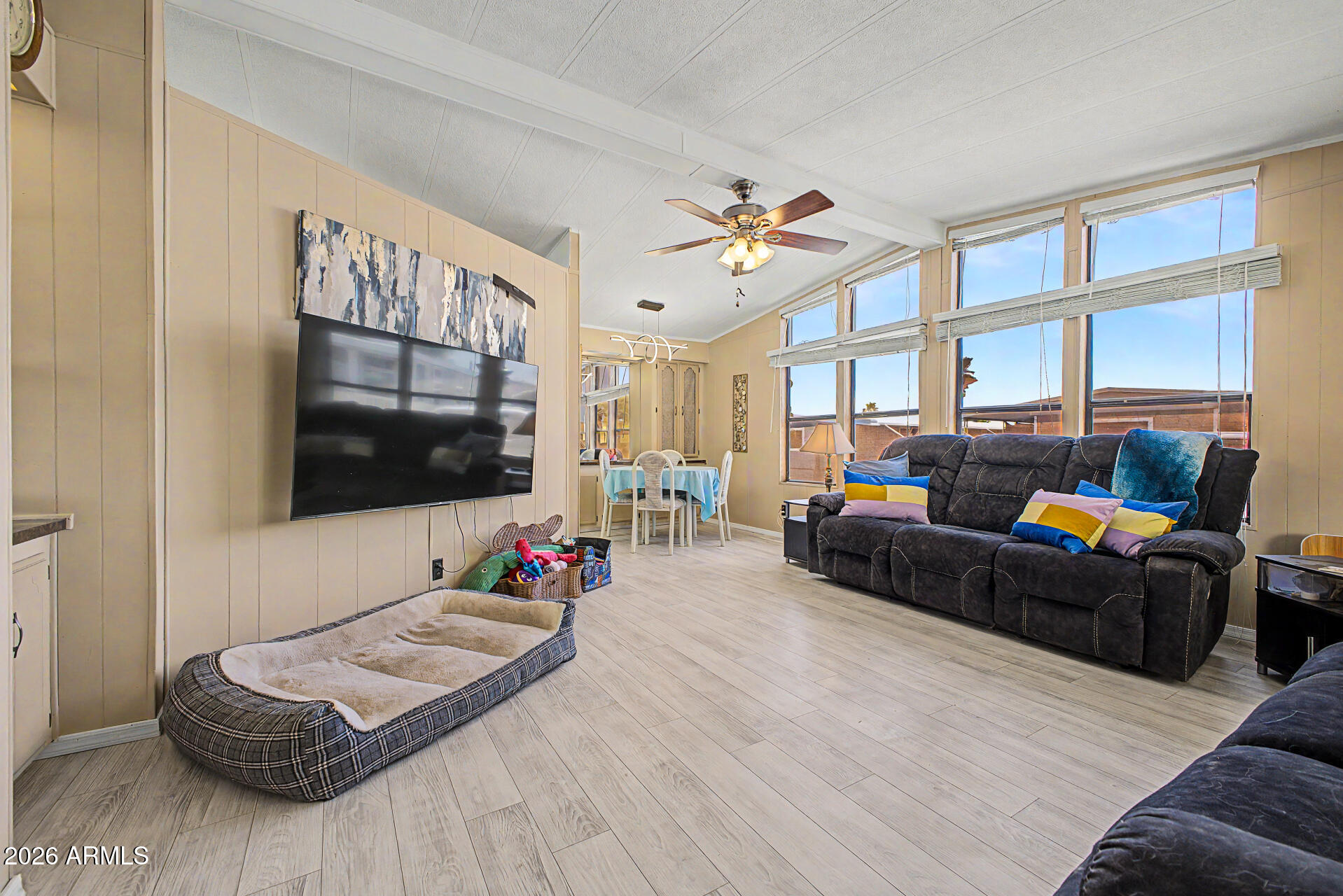 Contempo Tempe, a vibrant 55+ community that may allow residents 40+ with park approval. This well-maintained 2-bedroom, 2-bath home features plank flooring throughout, spacious living areas, and a layout designed for entertaining. Enjoy a separate living room, great room, dining area, and a large kitchen with abundant cabinetry and pantry storage. The primary suite offers a walk-in shower and generous closet space, while the guest bedroom is roomy and inviting. A large laundry room includes extra cabinets, built-in desk. Outside, relax on the covered deck, enjoy the fenced backyard. Storage shed . Community amenities include a clubhouse, fitness center, pool, spa, and social activities. Conveniently located near shopping, dining, entertainment, and Sky Harbor airport.