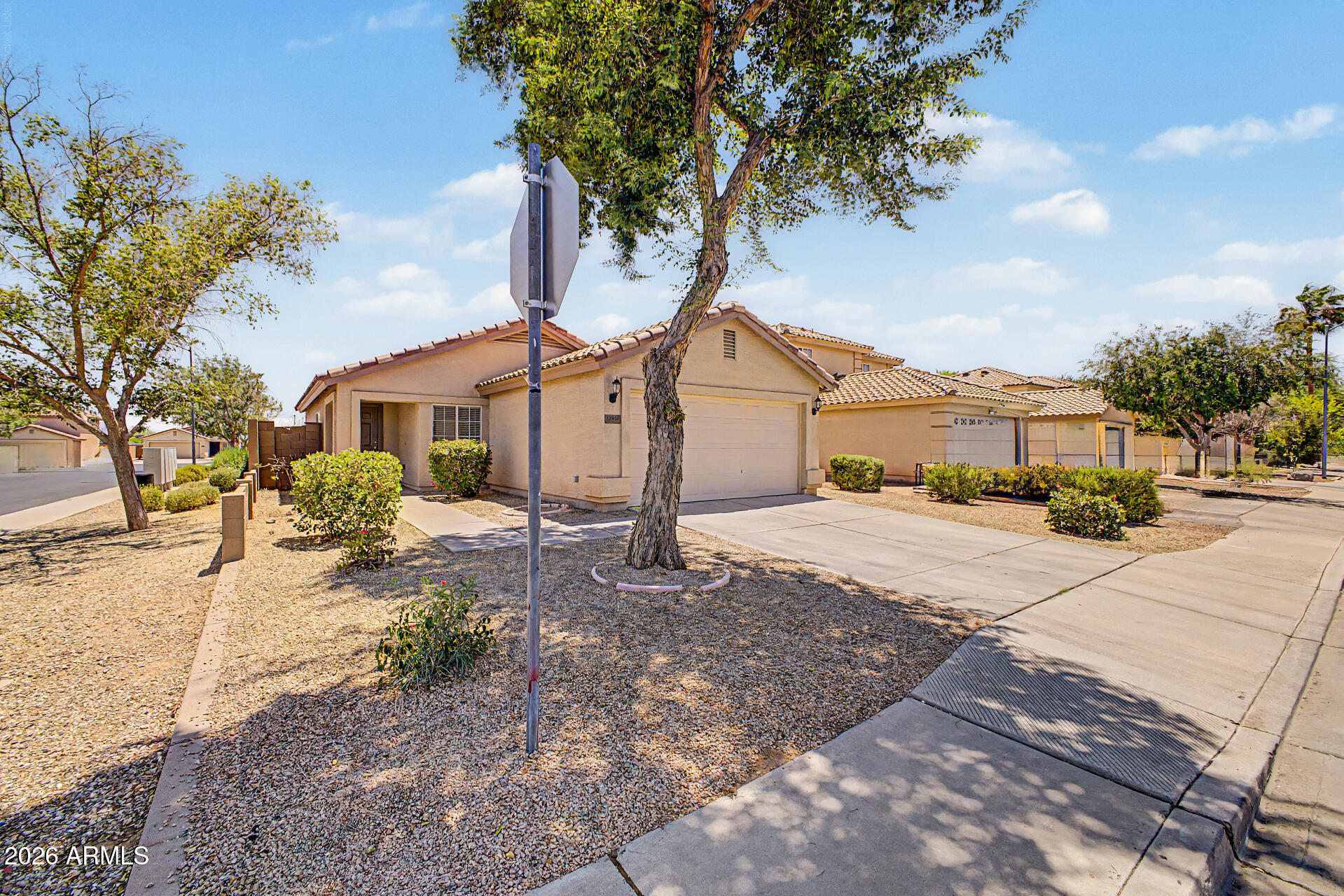 Beautifully maintained and move-in ready, this charming 3-bedroom, 2-bath home offers an open, light-filled floor plan with vaulted ceilings and stylish wood-look flooring throughout the main living areas. The spacious kitchen features crisp white cabinetry, stainless steel appliances, abundant counter space, and a sunny dining area with a sliding glass door leading to the covered patio--perfect for indoor/outdoor living.

The generous living room provides plenty of space for relaxing or entertaining, while the functional split layout offers comfortable bedrooms and privacy. Step outside to a covered patio overlooking a large, low-maintenance backyard with endless possibilities for creating your dream outdoor retreat, adding play space, or entertaining guests. Situated on a desirable corner lot, this home also features a 2-car garage, attractive desert landscaping, and a convenient location close to parks, schools, shopping, dining, and major commuter routes. Whether you're a first-time buyer, downsizing, or looking for an excellent investment opportunity, this home is ready for its next owner. Don't miss your chance to make it yours!