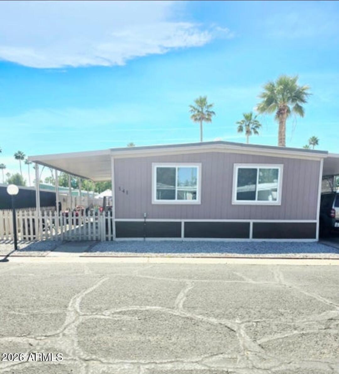 Welcome to this beautiful 3-bed, 2-bath home that features a spacious, light-filled living area that creates a warm & welcoming atmosphere, along with stylish wood-look vinyl flooring throughout. The kitchen provides ample cabinet space, perfect for storage & functionality, while the generously sized bedrooms offer comfort & flexibility. An indoor laundry room for convenience. Outside, you'll find a covered carport with space for two vehicles & a private backyard complete with a covered patio--ideal for relaxing or entertaining guests. The home also includes a newer AC unit for added comfort. Residents of this all-ages community enjoy access to a variety of amenities, including a heated pool, recreation hall with kitchen, fitness room and dog parks. Must be approved by the park!