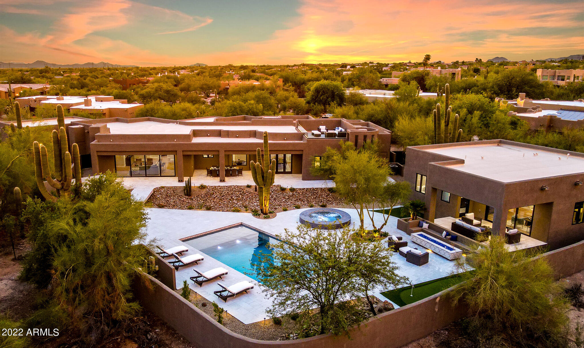 North Scottsdale Luxury Rebuild! Stunning 4 bedrooms + Office / 4 bathrooms and 5 car garage. Detached casita with additional 2 bedrooms, 2 baths, laundry room and kitchen. Main house is extensively rebuilt with new roof, spa, pool, septic, all new HVAC, plumbing, electric, windows, etc. Luxury interior design with state of the art appliances, custom cabinetry, millwork, lighting and tile details. Entertainers dream backyard with aluminum pergola over outdoor kitchen , putting green, mature saguaros, fire pit with built in seating and walk deck with glass railings, mountain and city light views in every direction. This house has it all and offers flexibility for every family.