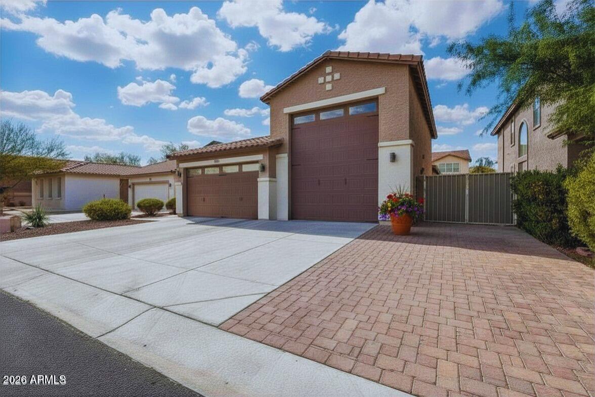 No Builder Headaches! Gated,Turn-Key Move-in Ready.Perfect for Large Trucks,Classic Cars,Toy Hauler,ATV's,Motor Cycles,Boats and only 20 Minutes to Lake Pleasant.40 Ft RV GARAGE w/ Extended 2 Car garage measured at 1,163 SQFT-Insulated & Air Conditioned w/ 50 Amp Plug, Epoxy Flooring,Custom Cabinetry w/ MASSIVE STORAGE SPACE to keep Sporting Equipment,Tools,Car Supplies & Holidays Organized.Tile Wood Flooring in the Spacious Great Room that has a OPEN-CONCEPT FLOORPLAN that flows into a CHEF'S KITCHEN Island w/Granite Counter Tops,Viking Stainless Steel Appliances,Wine Fridge,Lots of Storage space w/ UPPER & LOWER Cabinets,CUSTOM PLANTATION SHUTTERS,Stylish lighting,Designer Paint. LOW-MAINTENANCE FRONT & REAR LANDSCAPING w/Covered Patio,Custom Travertine & Turf Grass &