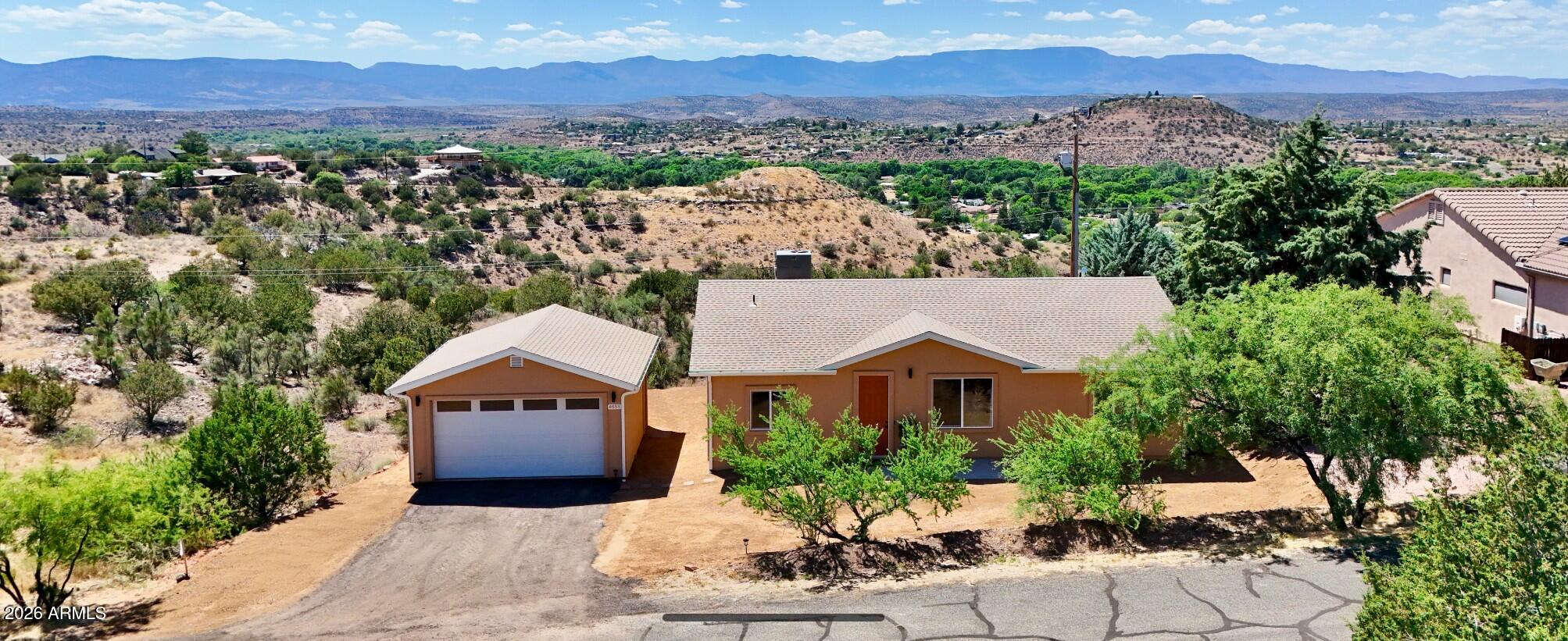 Brand new and built by a respected local builder, this beautiful 3 bedroom, 2 bathroom home with a 2 car garage offers the perfect blend of comfort, views, and peaceful country living in Rimrock, Arizona. Situated on an almost quarter-acre lot with paved road access, this property captures stunning mountain, desert AND greenbelt views! 
Enjoy watching a herd of deer that regularly visits the backyard while relaxing in the cozy back sitting area -- the perfect spot for your morning coffee or evening sunsets. Inside, you'll find a bright and open floor plan featuring an all-electric kitchen, spacious living areas, and a walk-in closet in the primary suite.
With quality craftsmanship, scenic surroundings, and plenty of outdoor space to enjoy, this brand-new home offers the tranquility of rural life, while still being conveniently located to Flagstaff, Prescott and Phoenix. Only a short walk from the Wickiup Mesa trail system, it is the perfect place for hiking, biking, walking your dog, and enjoying the beauty of the area.