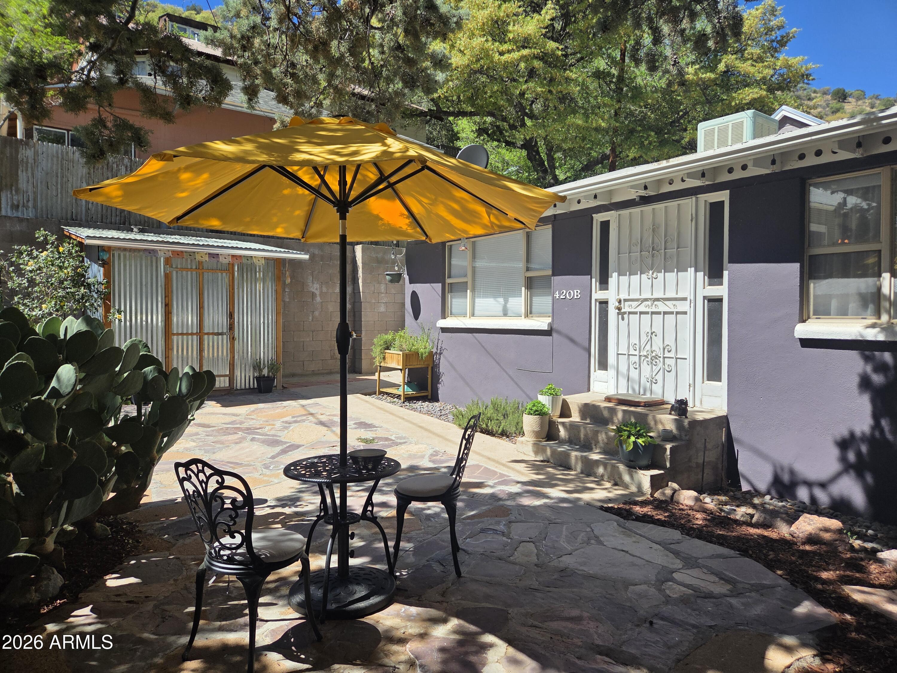 1931 Old Bisbee hideaway, parking and no stairs. 1,068' of calm, 2 bedroom 1 bath. Located in a tranquil area just off of Tombstone canyon. Arched entries into the dining and kitchen. Newer Gas range, dishwasher and Microwave.  Laundry room/storage located outside, includes stacked washer and dryer. Flagstone courtyard is protected with an aged and gorgeous Juniper tree. Water shut off valve, new pressure regulator and a water catchment tank have been added. A composed and appreciated property.  Tucked away off the tourist path, but within easy walking distance to downtown