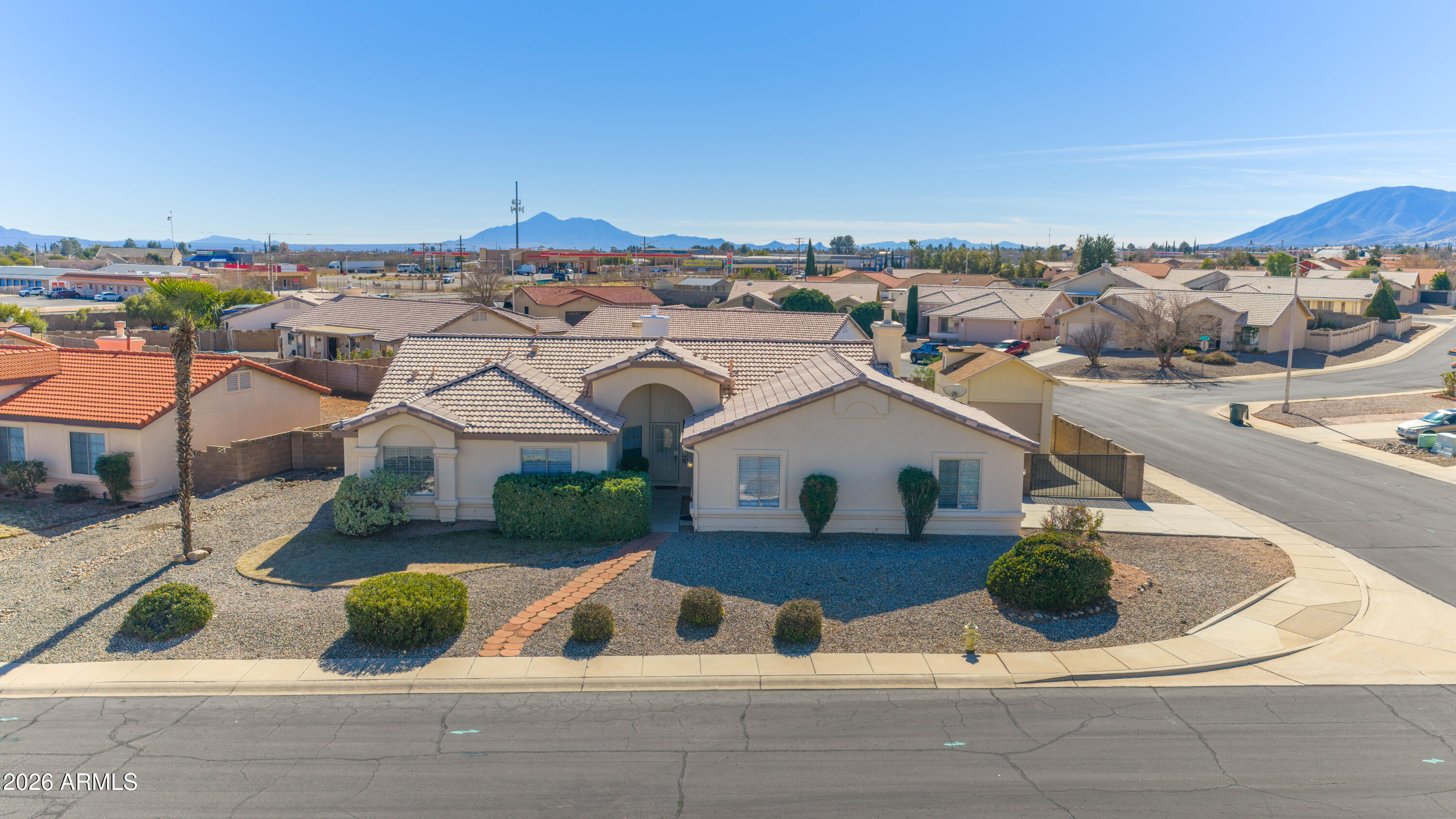 Spacious 2,700+ sq ft rental offering 5 bedrooms and 3 baths on a huge corner lot with stunning Huachuca Mountain views. This versatile home features a separate living and kitchen area with its own outside entrance, complete with a private bedroom and full bath—ideal for guests, extended living, or a private workspace, or as you see fit. Recent upgrades include new appliances, vinyl laminate flooring, updated fixtures, and blinds throughout. Multiple living spaces provide flexibility and comfort, while the expansive lot offers room to enjoy the outdoors and scenery. Conveniently located near shopping, dining, and Fort Huachuca. Move-in ready—schedule your showing today.