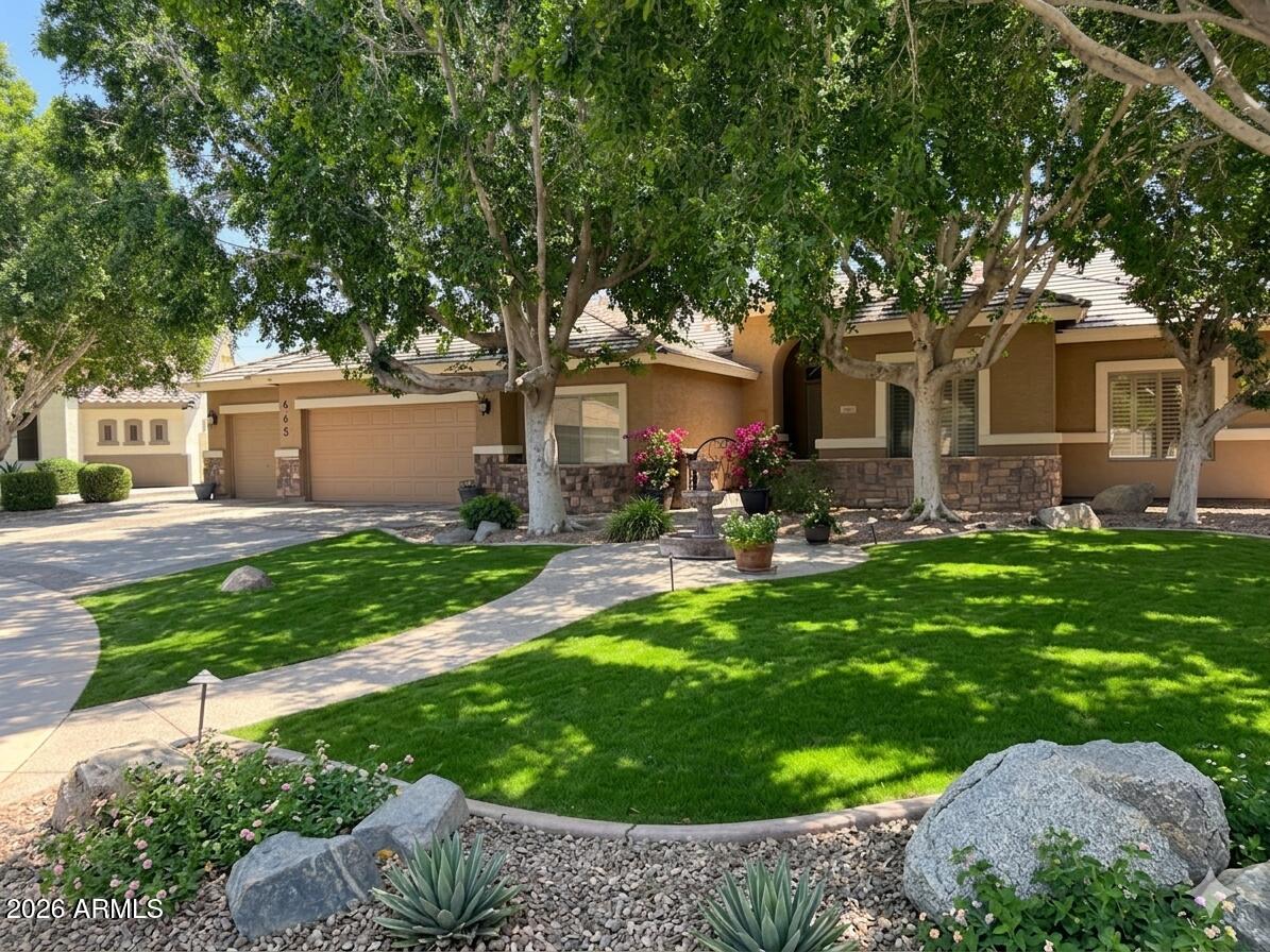 $50,000 Built in EQUITY! Luxury living in one of Gilbert's most desirable and exclusive communities near Lindsay Meadows. This beautifully blends elegance with resort-style outdoor living. Step inside to soaring ceilings, expansive living spaces, custom architectural details, and abundant natural light. The chef-inspired kitchen features rich cabinetry, granite countertops, an oversized island, and upgraded stainless steel appliances perfect for entertaining. Escape to your private backyard oasis showcasing a stunning lagoon-style pool, lush landscaping, mature palms, rock accents, and tranquil resort vibes. Ideally located near top-rated schools, shopping, dining, SanTan Village, and freeway access, this home delivers the perfect blend of comfort, luxury, and Arizona living.