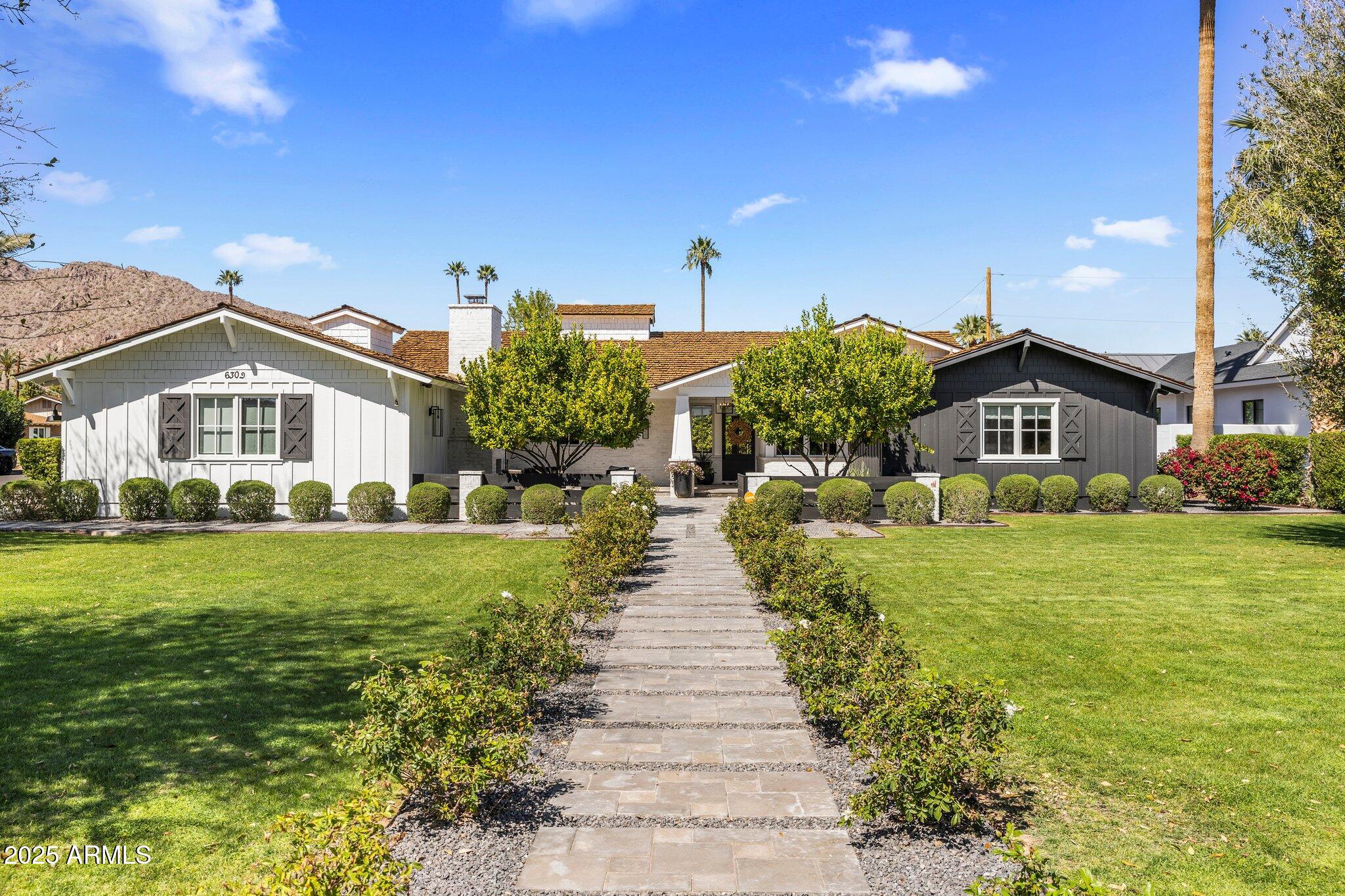 Within view of Camelback Mountain in the highly coveted Arcadia Proper neighborhood, this extensively updated home masterfully combines timeless luxury with modern farmhouse design. Set on an expansive 19,000+ sq ft lot, the property is surrounded by lush, manicured landscaping, including mature citrus trees and blooming white roses, creating a private and picturesque retreat. A front courtyard, complete with seating area and wood burning fireplace, creates a welcoming entrance to the home.

Inside, rich oak wood floors, custom millwork, and high-end finishes enhance the warm, sophisticated atmosphere throughout home which features 5-bedrooms, 4.5-bathrooms, an office and a bonus room. More.. One of the front bedrooms features its own private entrance and ensuite bath, ideal for a mother-in-law suite or independent teen space.

At the heart of the home is a stunning chef's kitchen, thoughtfully designed with two farmhouse sinks, dual dishwashers, high-end appliances, and generous counter space. Beautiful windows flood the space with natural light, creating an inviting environment for cooking, gathering, and entertaining.

The main living area opens seamlessly to the outdoors with 15-foot sliding doors that lead to a spacious covered patio overlooking a sparkling heated pool and gas fire pitperfect for year-round entertaining and relaxation. A 3-car garage completes this exceptional property, offering both functionality and style in one of Arcadia's most desirable locations.