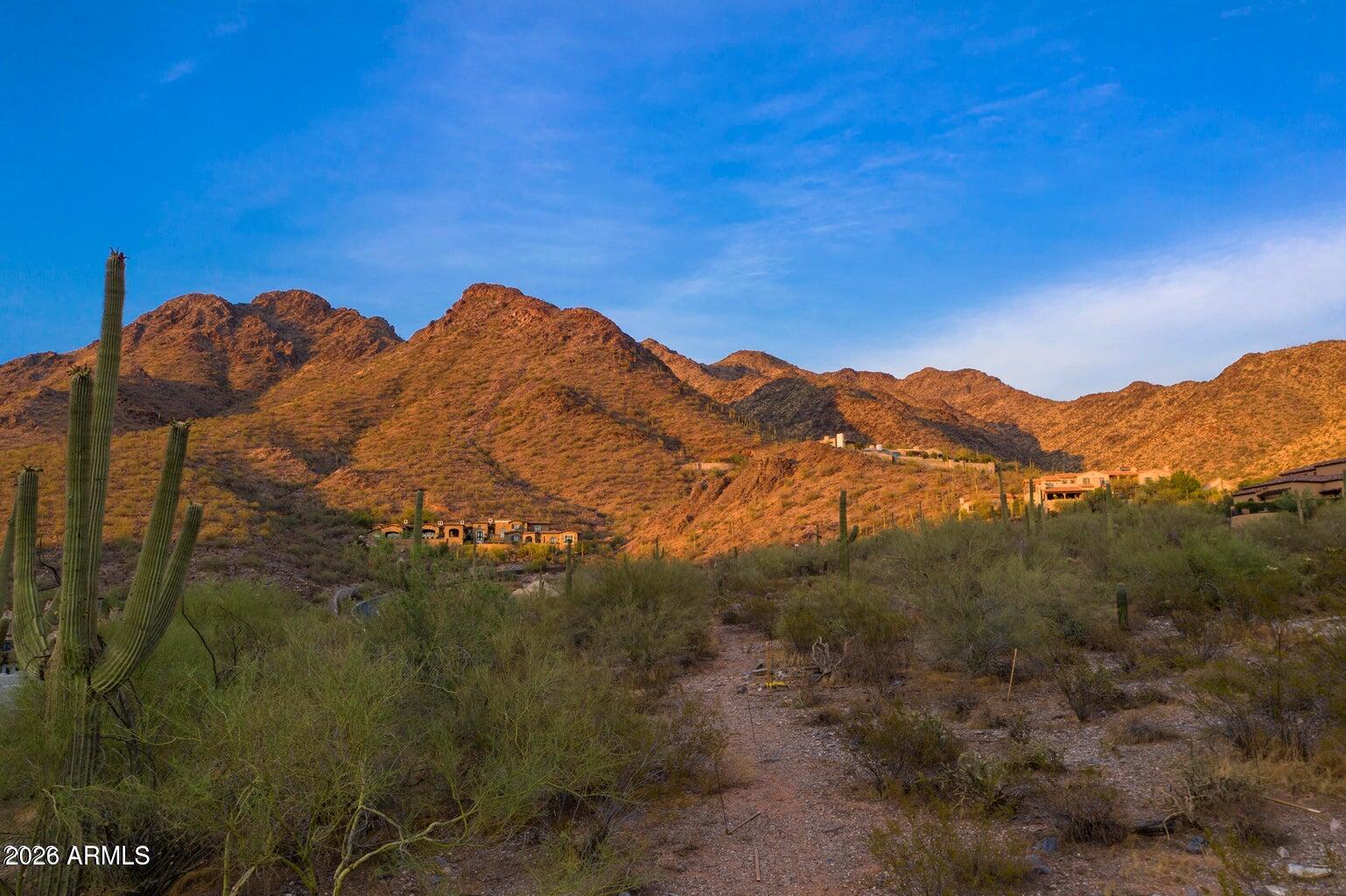 Set on nearly 3 acres in the prestigious Upper Canyon of Silverleaf, this exceptional homesite sits at an elevation of approximately 2,270 feet, offering breathtaking vantage points while still allowing for a relatively easy build with minimal elevation change across the lot. The building envelope is thoughtfully positioned deep within the property, creating a sense of privacy, exclusivity, and a dramatic approach upon arrival.

From the elevated building pad, a newly constructed home can capture sweeping city light views along with stunning surrounding mountain views, creating a truly spectacular backdrop from nearly every angle.