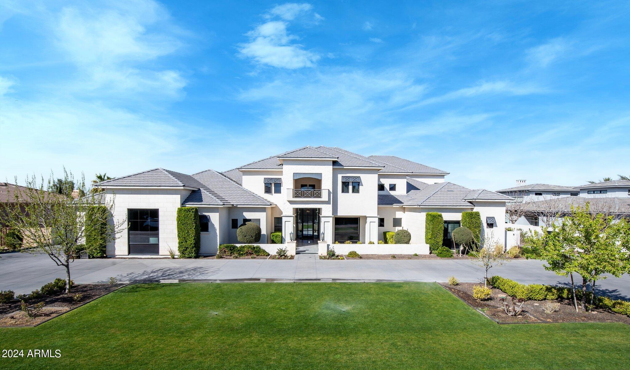 Nestled on just under an acre, this expansive property boasts a 4 bedroom, 3.5 bathroom main residence spanning 8,925 sq ft, complemented by a 2 bedroom, 2 bathroom casita. The stunning owner's suite features his and hers walk-in closets, ensuring ample space and privacy. A 5-car garage provides plenty of room for vehicles and storage. Indulge in luxury with a steam shower and numerous other amenities that this property offers. If you're looking to relive the joys of youth, this is the place for you. Enjoy an indoor basketball court, a private skatepark, a built-in trampoline, and a diving platform that leads into a sparkling pool with a slide. This property truly has it all for those seeking a playful and opulent lifestyle.