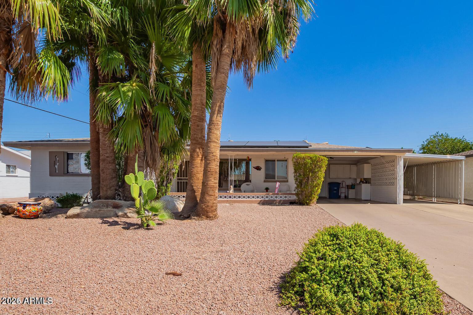 Enjoy all of the amenities Dreamland Villa adult community has to offer with NO HOA! Only one resident must be 55+ years old, no one under 19 living in the home, & there is a voluntary club membership for $270 annually that allows access to an array of amenities. This single-story 2-bed, 2-bath residence with an Arizona Room is the one you've been waiting for! Featuring charming curb appeal, low-maintenance landscaping front & back, plus dual carport parking. You will appreciate solar that helps keep utility costs down, along w/a newer A/C (2025) & roof (under 10 years) for energy efficiency. This lovely home offers the perfect blend of comfort, style, & convenience. Discover a spacious living area w/elegant wood-look flooring & custom palette throughout. The adorable eat-in kitchen is retro-style & equipped w/ample cabinetry, mosaic tile backsplash, built-in appliances, & track lighting. The functional laundry room easily allows room to complete daily tasks & pursuee your favorite projects. Primary bedroom includes a ceiling fan, dual closets, & a restroom right next door for added convenience.

Another full bedroom includes a ceiling fan & ample closet space. Cozy up in the sunroom complete w/a full bathroom, currently used as an additional bedroom. This is a great space to forget about the weather & marvel at a relaxing sunrise or sunset. Enjoy outdoor living on the inviting front porch or in the spacious fenced backyard perfect for relaxing or entertaining w/covered patio, extended seating area, & massive storage shed. The property also includes a 2-car carport & a spacious driveway. 

At Dreamland Villa, you will be part of a vibrant 55+ community. You'll find a welcoming atmosphere, neighborhood amenities w/a wide range of activities including clubs, pools, pickleball, workout facility & more. With its combination of updated features, low-maintenance living, & inviting spaces inside & out, this property is ready for you to move right in!