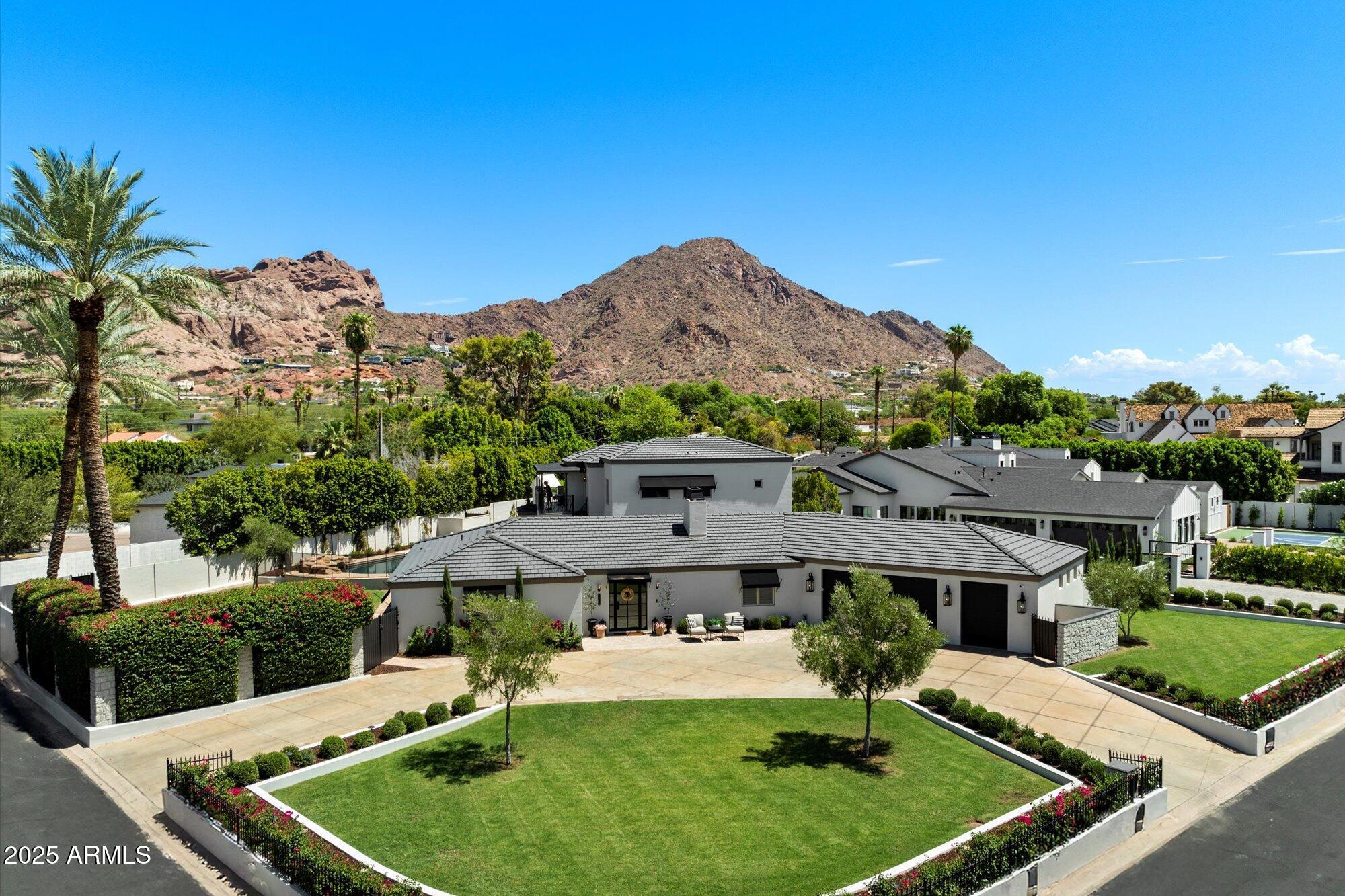 A RARE OPPORTUNITY to own a home in the heart of Arcadia Proper! This property is priced well below recent appraisals which offers immediate built-in value! Step into this lovely 4-bedroom home that has been newly reimagined with timeless charm and modern style, ideally located on Exeter Blvd in one of Phoenix's most desired neighborhoods. Set on a large corner lot, this home features a circular drive, mature landscaping, multiple outdoor spaces and stunning Camelback Mountain views that create exceptional curb appeal. With over 4,000 sq ft of thoughtfully designed living space, this residence also includes a full bonus room, loft, and flexible area for office/studio space, providing versatility for today's lifestyle. The oversized 3-vehicle garage adds both convenience and ample storage. Just outside, enjoy an outdoor BBQ and dining area complete with a built-in Blackstone grill, perfect for gatherings and everyday living.
The spacious primary suite is a peaceful retreat featuring abundant natural light and a generous walk-in closet with excellent storage. Additional bedrooms are well-positioned for comfort and privacy.
Enjoy a resort-style backyard with a sparkling pool, expansive grassy lawn, lush landscaping, and a dedicated kids' playground area, ideal for relaxation, entertaining, and play.
Move-in ready and perfectly situated near top-rated schools, premier shopping, golf, and within walking distance to The Henry, Steak 44, and Global Ambassador, this exceptional home offers the very best of Arcadia living. Welcome home.