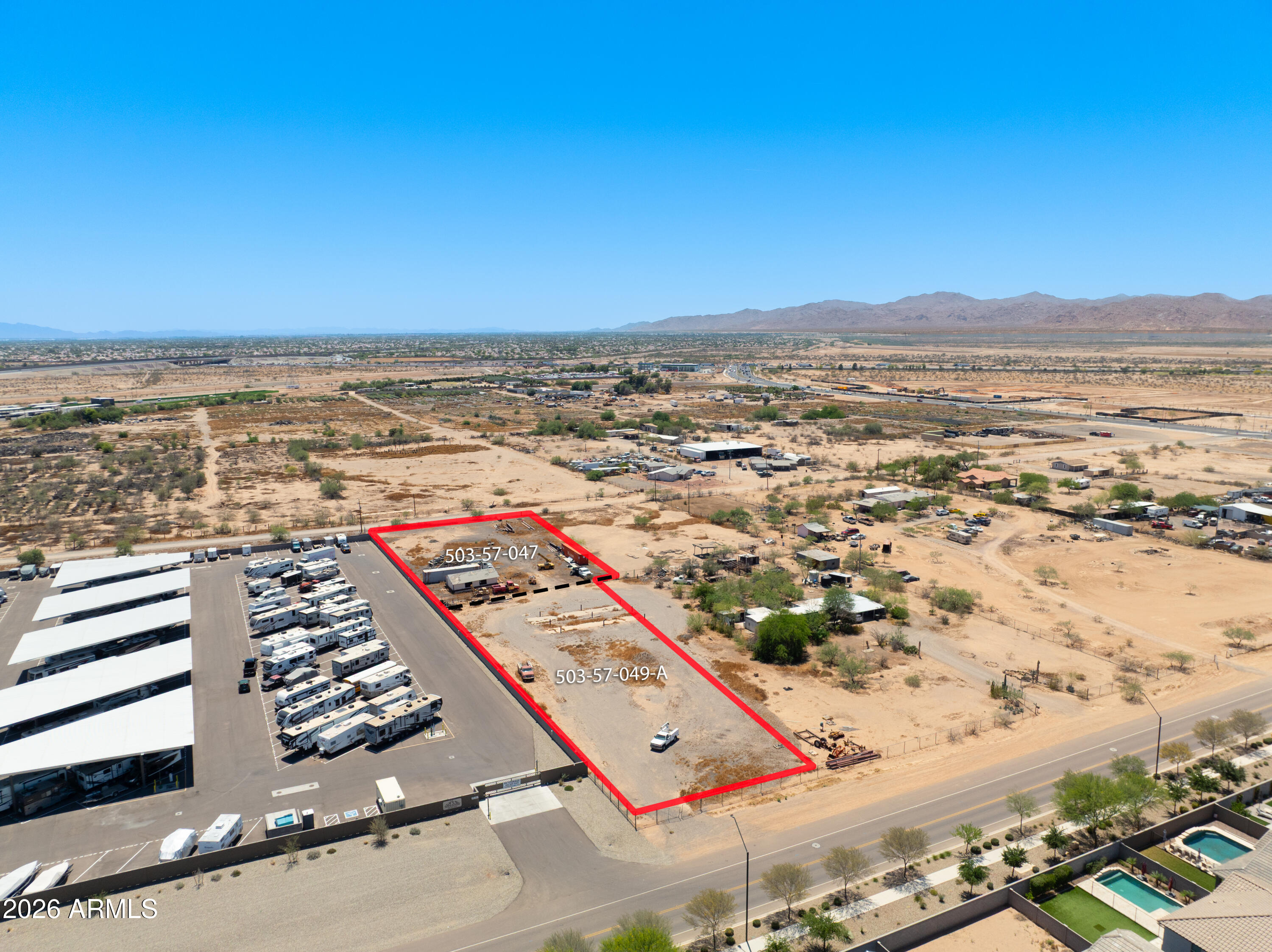 Rare opportunity to own approximately 2.37 acres in one of Surprise's fastest-growing areas. Two parcels being sold together (APNs 503-57-149A and 503-57-047), offering exceptional flexibility and potential with NO HOA restrictions. Ideal for a custom home, horse property, RV garage, workshop, or investment opportunity. Located adjacent to commercially used property, the parcel may offer future commercial potential through the City of Surprise Special Use Permit process. Enjoy plenty of room for horses, toys, and outdoor living while remaining conveniently close to shopping, dining, schools, and major transportation corridors. Beautiful desert views, this property offers privacy, versatility, and long-term upside potential!