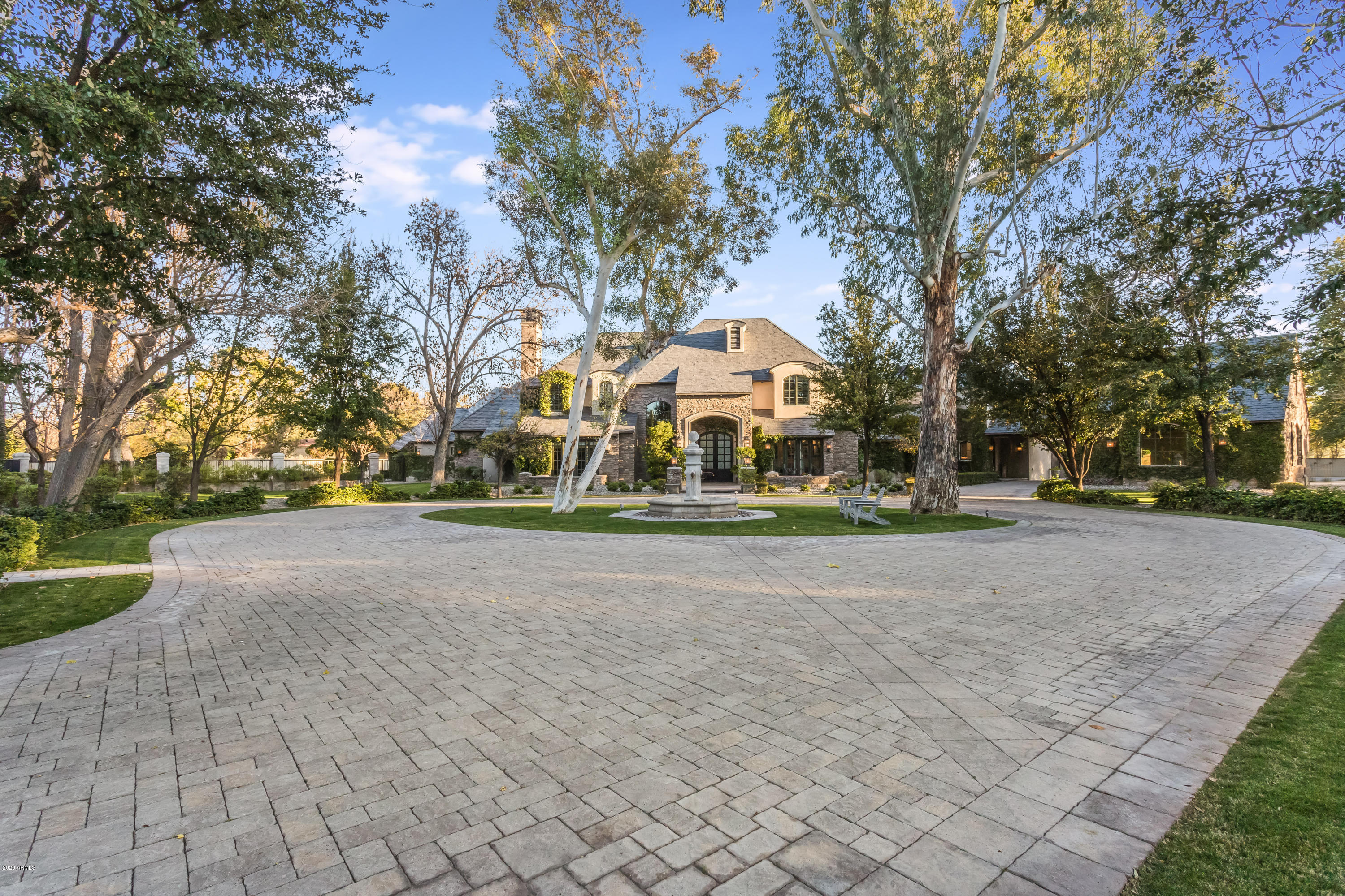 ONE OF A KIND GATED ESTATE. CALVIS WYANT DESIGNED AND BUILT FOR THE SELLERS. NO EXPENSE SPARED. WHY CHOOSE TO LIVE ANYWHERE ELSE? WITH EASY ACCESS TO ALL AREAS OF TOWN, AIRPORT AND THE BEST RESTAURANTS & SHOPPING IN THE CITY. INCREDIBLE FRENCH CHATEAU SITUATED ON 2 ACRES & HAS IT ALL: CUSTOM MILLWORK, MEDIA ROOM, FITNESS ROOM ,GAME ROOM W/A FULL BAR,GUEST HOUSE & A WINE CELLAR. GOURMET KITCHEN HAS ZINC COUNTER TOPS, SUB ZERO & VIKING APPLIANCES & BEAUTIFUL CABINETRY. LG FR,LUXURIOUS MASTER SUITE W SITTING AREA & MULTIPLE FP'S. INCREDIBLE YARD: POOL RAMADA,IMPORTED FOUNTAINS,663 SQ FT GUEST HOUSE & OUTDOOR KITCHEN. THERE IS A 2ND GATE OFF 22ND ST,. 4 CAR GARAGE+2 CAR DETACHED GARAGE + PARKING FOR ALL OF YOUR FRIENDS!
