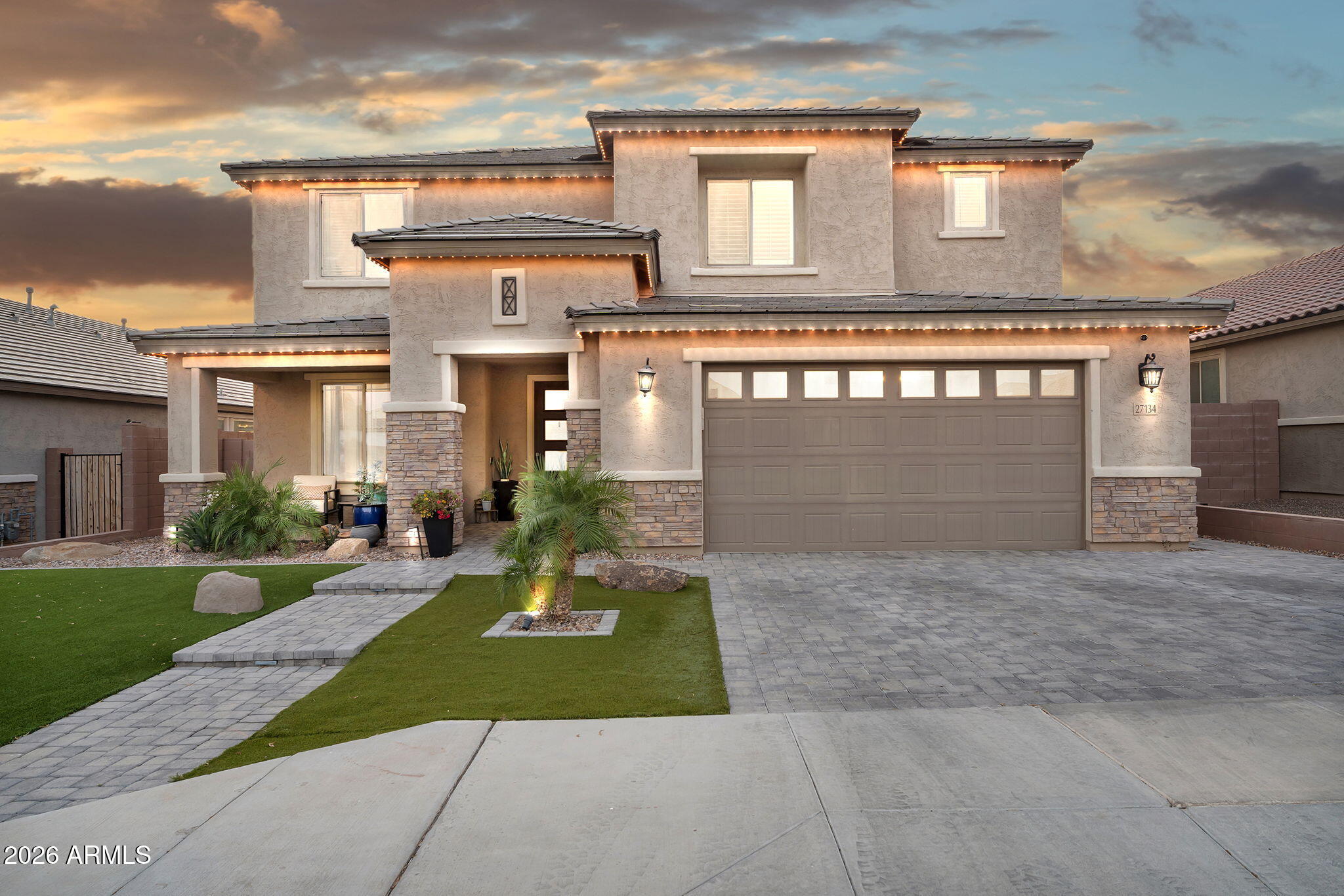 Experience refined desert living in Peoria with this beautifully designed home featuring low-maintenance landscaping and a covered entry porch. Inside offers an open floorplan with living room, family room, formal dining, and a versatile loft. The kitchen showcases quartz countertops, island, breakfast bar, stainless steel appliances, tile backsplash, and pantry. Includes office, laundry with sink, surround sound, security cameras, and plantation shutters on all bedroom windows. Primary suite features a huge walk-in closet, double vanity, and step-in shower. The 2.5-car insulated garage boasts epoxy flooring and built-in cabinetry. Resort-style backyard includes pool, spa, fire pit, covered patio, pergola, built-in grill, and permanent exterior lighting.