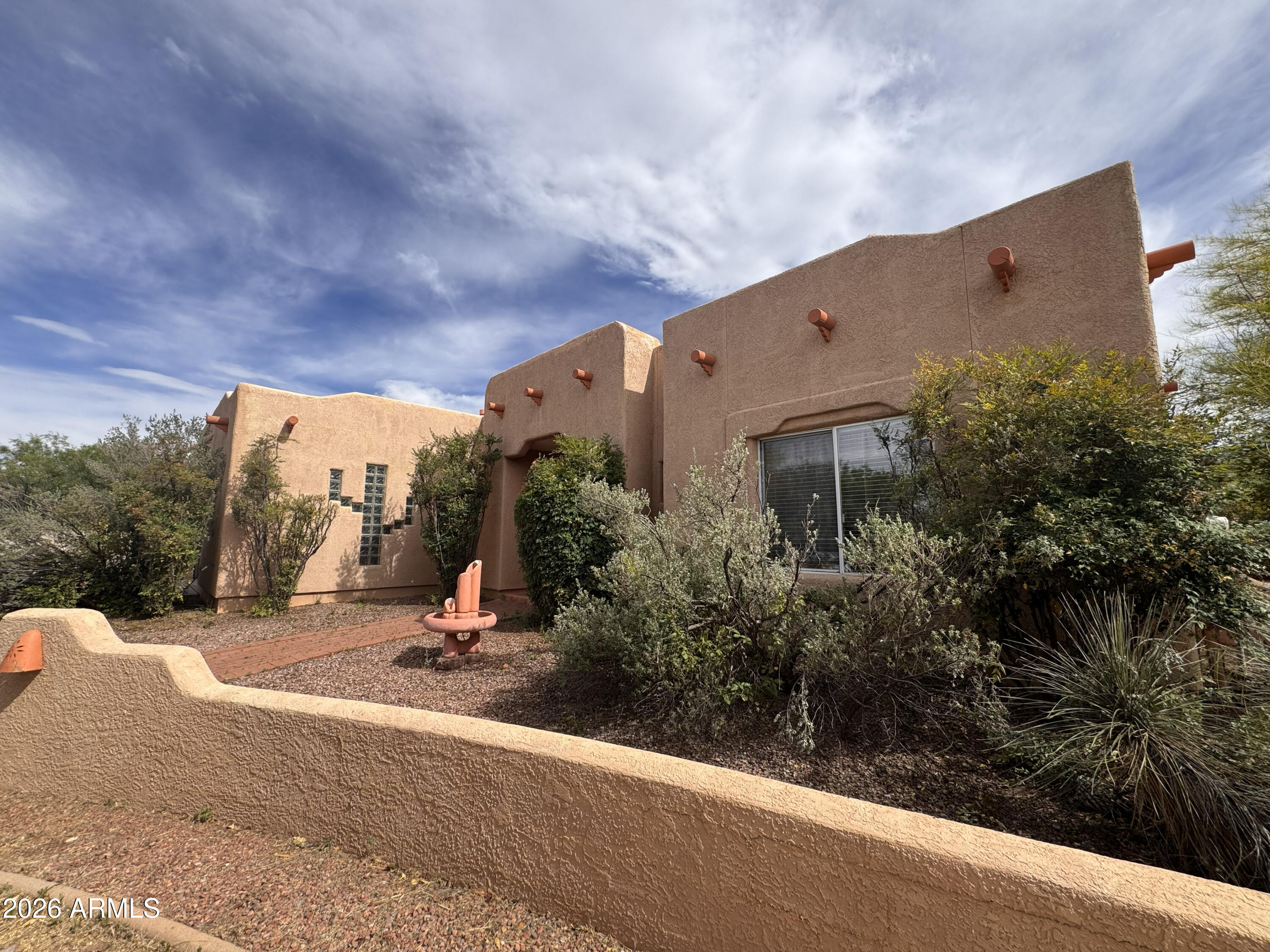 Lovely Santa Fe-style home in Mountain Shadows! Featuring 3 bedrooms, 2 bathrooms, a light-filled interior, and a spacious 2.5-car garage. Kitchen offers abundant cabinets and counter space, eat-in area, and opens to the family room for easy living and entertaining. Primary suite features French doors into the room, bay window, and a private door to the back patio. Ensuite includes a walk-in closet and separate tub and shower. Guest bedrooms are split from the primary for privacy. Living room opens to a large, covered patio. Backyard is expansive, mostly enclosed with block wall and chain-link fencing, plus a separate fenced area for garden or dog run. New roof 6/2026. Home is ready for a new owner's vision and updates, and the price reflects the opportunity to make it truly your own.