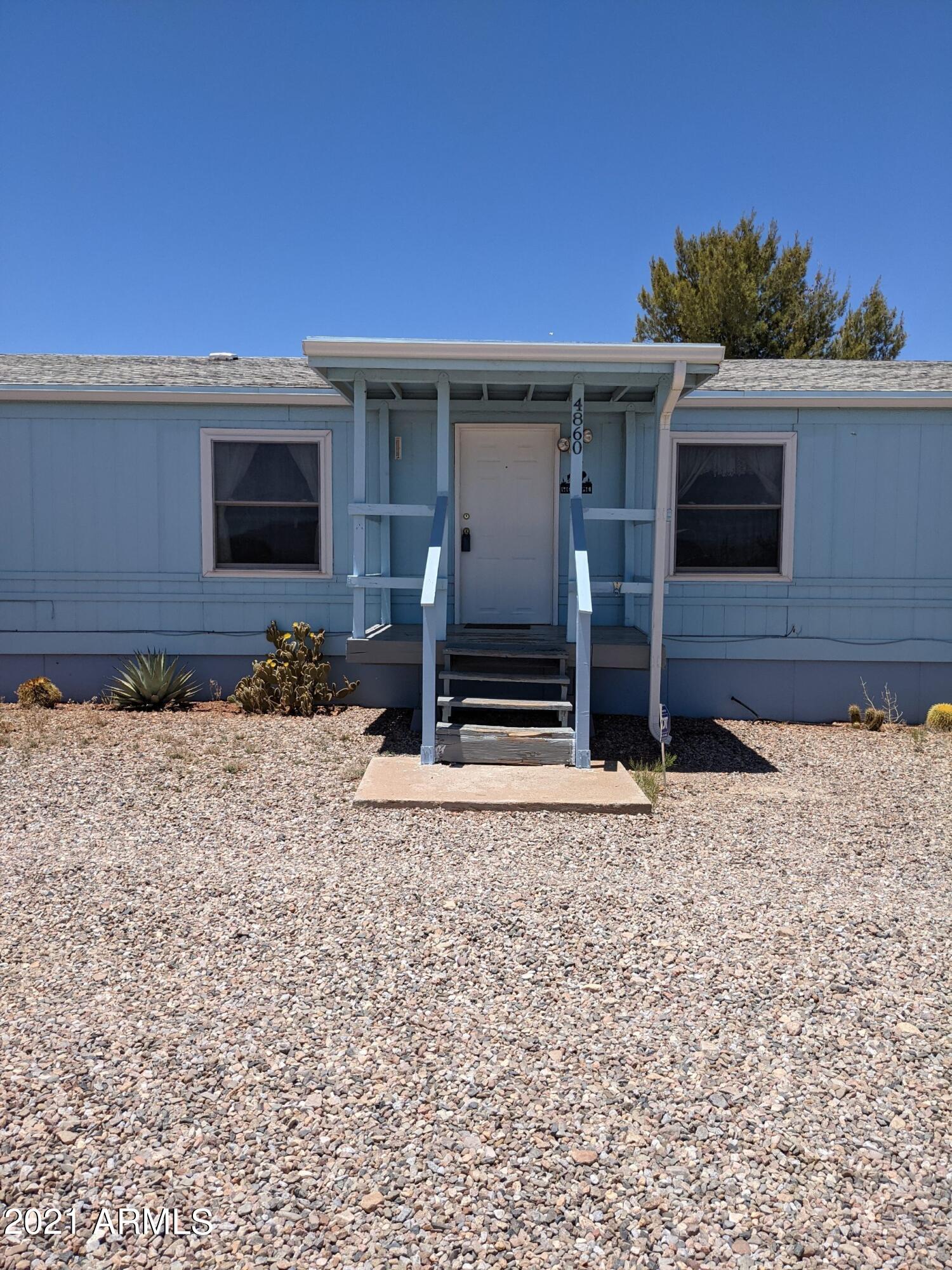 Fourth bedroom possible, full back porch, fenced back yard, fenced dog run, 3 sheds (2 with electricity) well share. Home sets up for great views. Refrigerator included.