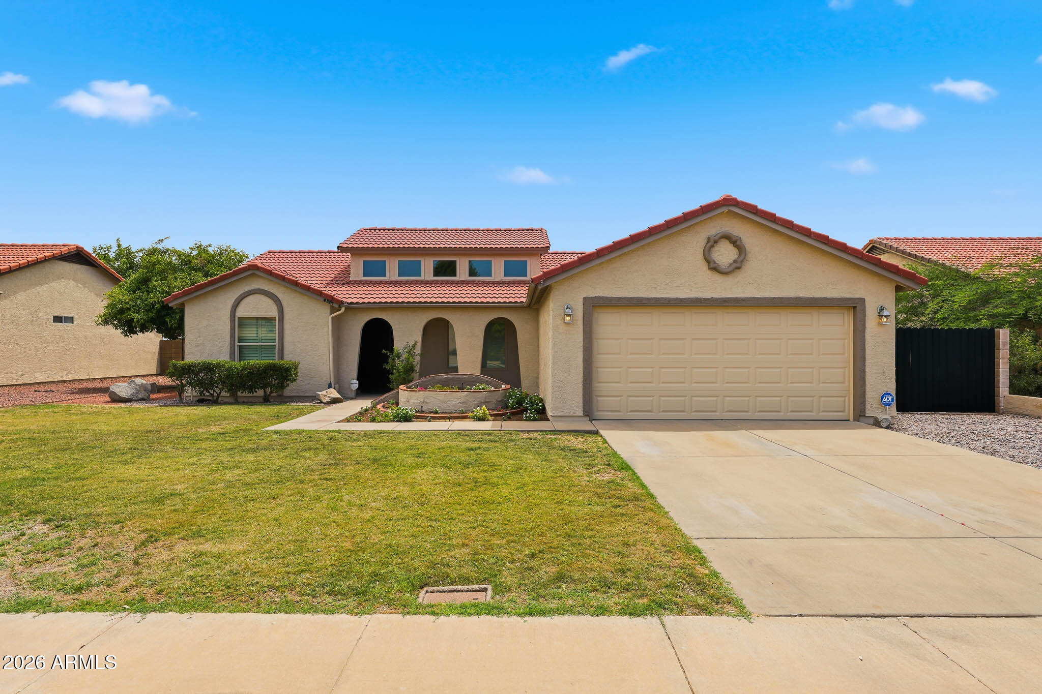 Welcome to a place where you can truly plant roots. This home greets you with beautiful curb appeal, featuring lush green grass and a lovely raised flower bed, plus the freedom of no HOA and an RV gate.

Inside feels completely fresh and bright, thanks to vaulted ceilings, brand-new carpet, and a professionally painted inside and out. It's totally move-in ready with a 2022 roof and newer double-insulated windows. A huge plus for a growing family is the bonus den attached to the main bedroom, it's the absolute perfect setup for a nursery or a quiet home office.

The backyard is perfect, private and mature landscape, featuring a brick pavered covered patio, garden beds, and built-in BBQ for weekend cookouts. Plus, you're just one block from Sahuaro Ranch Park for easy family walks!