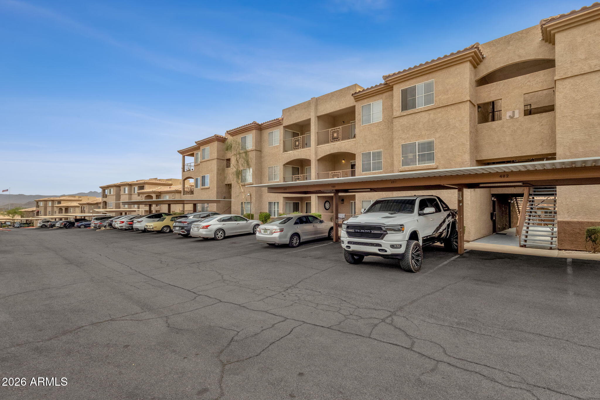 Step into easy desert living in this updated 1-bedroom, 1-bath condo with 778 square feet located in the sought-after Four Peaks community of Fountain Hills. With a private exterior entrance and a smart, efficient layout, this residence delivers comfort and functionality in a low-maintenance setting.

Inside, wood-look flooring and soft neutral finishes create a light, open atmosphere. The main living area flows seamlessly into the kitchen and dining space. The kitchen is appointed with white cabinetry, dark countertops, stainless steel appliances, modern fixtures, and a convenient breakfast bar for casual seating. Large windows and sliding glass doors invite in natural light and lead to a covered balcony. The spacious bedroom features plush carpeting, a ceiling fan, and ample closet space, while the bathroom showcases clean lines and contemporary finishes. A stacked washer and dryer are conveniently located inside the unit, along with additional storage. Carport or attached-garage parking adds practicality and convenience.

Four Peaks residents enjoy access to resort-inspired amenities, including an outdoor pool, spa and hot tub, steam room and sauna, fitness center, theater room, business center, BBQ grilling stations, and meticulously maintained landscaping throughout the pet-friendly community.

Situated in an International Dark Sky Community, Fountain Hills is celebrated for its striking desert scenery and brilliant night skies. With quick access to the 101 and 87, commuting across Maricopa County is convenient, and downtown Fountain Hills is just minutes away. This condo presents a fantastic opportunity to enjoy relaxed Arizona living in a prime location.