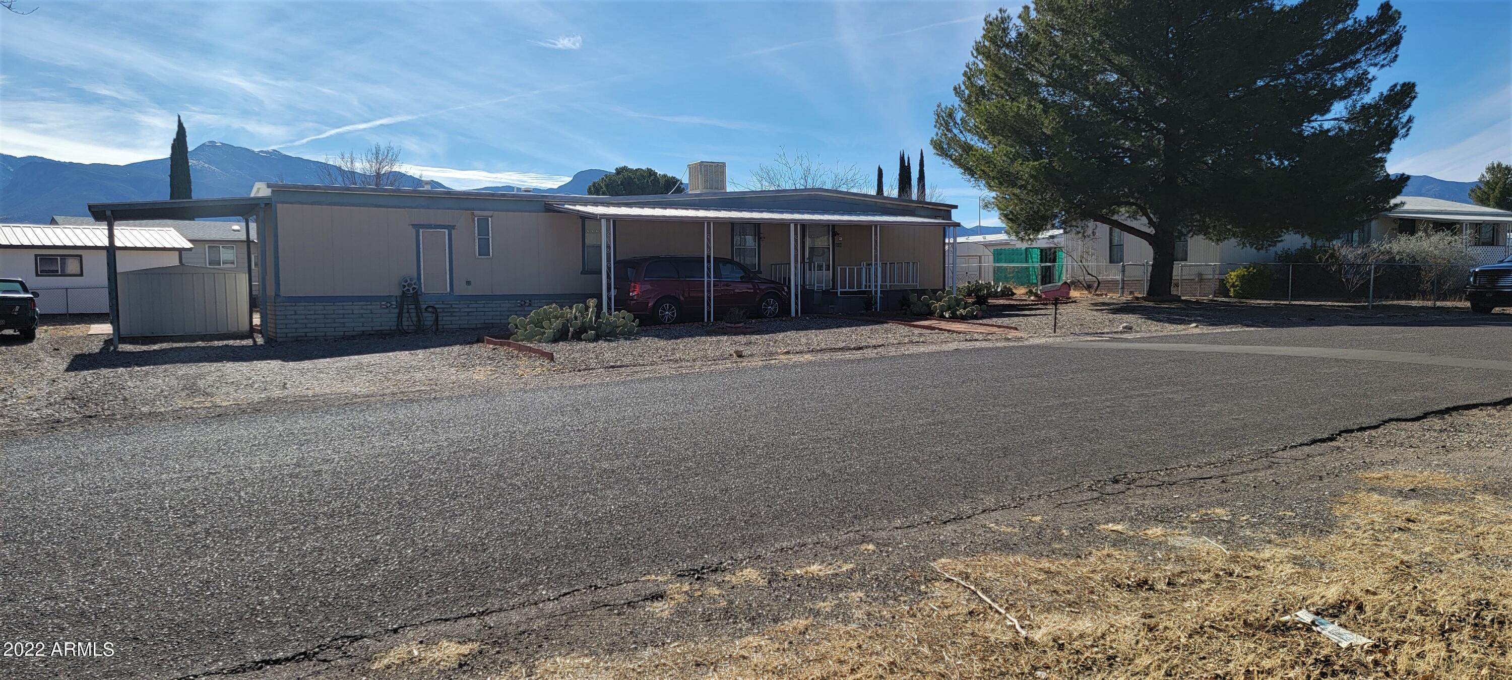 The will absolutley love this well cared for doll house! It is immaculate inside. There is an eat in kitchen with 2 pantries, gas range, dishwasher and fridge. There is a breakfast bar at standard table height making it very safe and convenient. The bath has a newer walk in shower and toilet. The closets are good sized and there are ceiling fans in the living room and master bedroom. Outside there are 2 covered decks, 2 carports and a 1 1/2 car garage with workbenches and great lighting. There are RV hookups for your visitors as well. Low maintenance landscaping make this home easy to take care of. All furnishing will remain in the home minus some personal items.  Call today for your private showing.