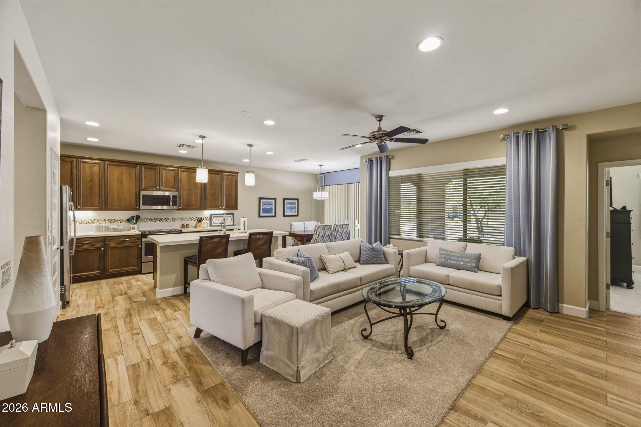 Absolute DREAM Villa!  This breathtaking, designer former model end-unit home is the perfect blend of luxury and convenience--completely turnkey and move-in ready.  
Step inside to discover stunning finishes and thoughtful design from top to bottom. This home comes fully furnished with high-quality furniture, art, bedding, linens, kitchenware, and appliances--everything you need is already here.   Enjoy premium upgrades throughout, including Elegant quartz countertops, Soft-close cabinetry and undercabinet lighting in the kitchen, Stylish 6-panel doors, Epoxy-coated garage floors and Custom window coverings.  highly sought-after Robson Ranch community, offering an exceptional lifestyle and amenities. Waiting for the fussy buyers to make this your new home! This was a ''STAY AND PLAY UNIT!
