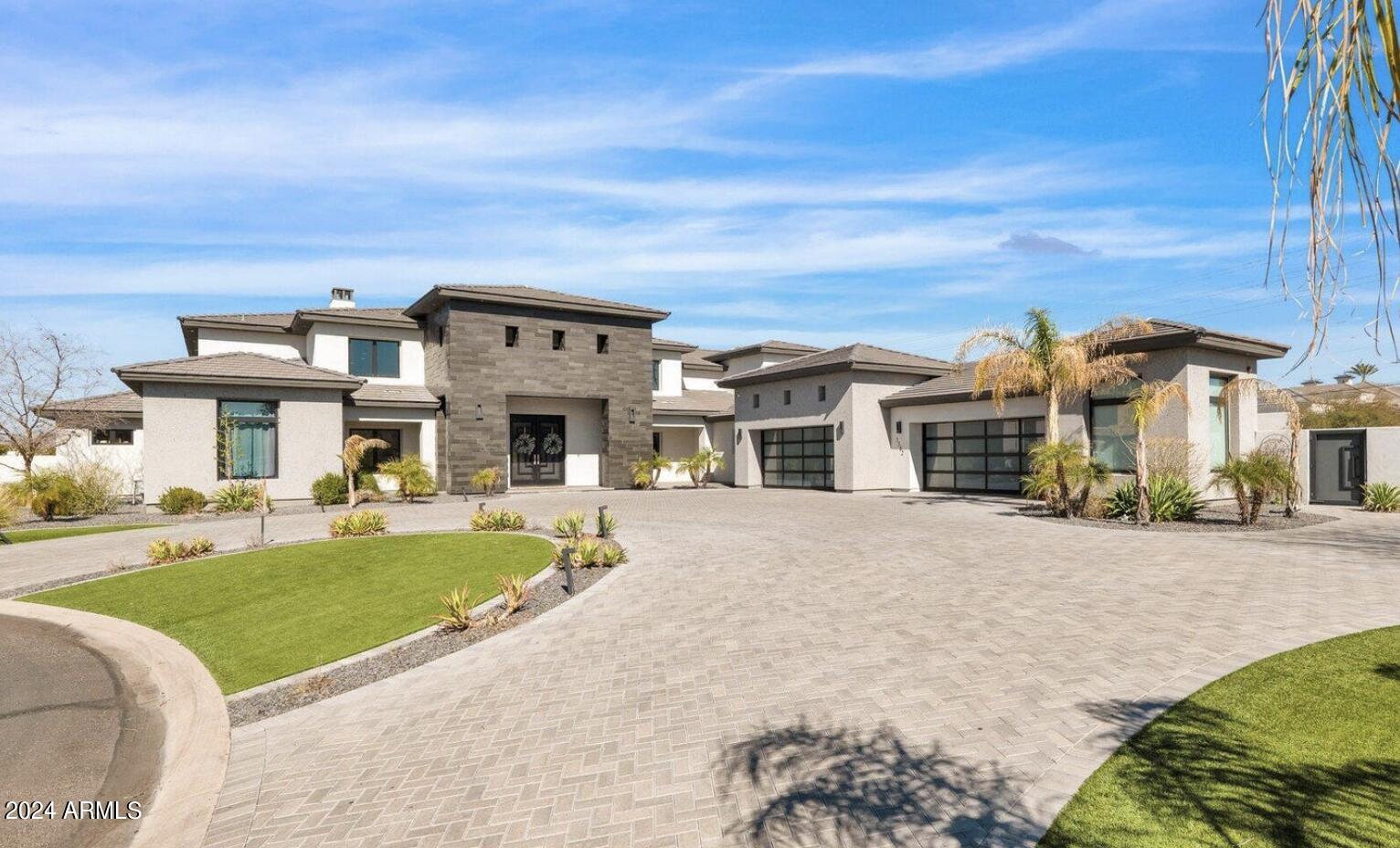 Welcome to this breathtaking 8 bedroom, 7 bathroom estate in the prestigious Montana Dorado neighborhood, spanning an impressive 9419 square feet. A dramatic double staircase and designer lighting greet you upon entry, setting the stage for the luxury that unfolds. To the left, a formal living room, and to the right, a dining room capable of hosting a 16-person table, showcase the home's grandeur. High-end tile guides you to an expansive family room with 22' ceilings and a striking floor-to-ceiling brick fireplace. The chef's dream kitchen features a large granite-topped center island, breakfast nook, and premium appliances including Sub-Zero and Wolf, complemented by a large butler's pantry and wine cooler. Pocket sliding glass doors open to a covered patio and a backyard oasis with a lengthy pool, slide, waterfall, swim-up bar, jacuzzi, and a step-down BBQ area, perfect for entertaining. Enjoy two glass fire pits, an in-ground trampoline, and a putting green, all with the privacy of no backyard neighbors. The home also boasts an office, workout studio with a dual head steam shower, game room with kitchenette, and two generous laundry rooms. Security is paramount with commercial steel exterior doors, hardwood 8' interior doors, and a home security system with cameras. The 4-6 car garage features EV Charging, built-in cabinets, epoxy floors, and a mini split room. An RV gate adds to the convenience. This home is a masterpiece of design and functionality, offering unparalleled luxury and comfort.