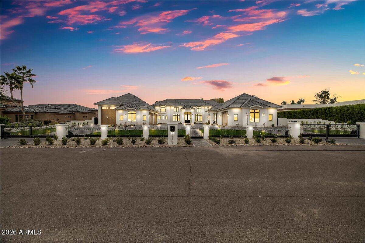 This is a one-of-a-kind newly built estate offering refined craftsmanship and timeless French Chateau architecture that can only be found in the heart of Cactus Acres in coveted Cactus Corridor. The home is a fully and privately gated property that features two electronic iron gates and a dramatic circular drive and motor court that can accommodate dozens of cars. The 7847 sq. ft. residence includes 6 en-suite bedrooms, 7 full baths, and 3 half baths. Living spaces are both elegant and functional, with formal living and dining rooms, a spacious family room, dedicated den/exercise room, and a media/golf simulator/flex room complete with its own bar with ice makers, wine frig, and beverage center.
The chef's kitchen is designed for serious entertaining, showcasing Wolf and Sub-Zero Wolf and Sub-Zero appliances, quartz countertops, an oversized island, and exceptional storage. The butler's pantry offers additional wine storage, microwave, and dishwasher. While the prep kitchen is equipped with a range, dishwasher, and built-in refrigerator and freezer.
A dining room bar includes wine refrigeration, beverage refrigerator, and ice maker as does the bar in the media/flex space.  The serene primary suite features a fireplace and a spa-inspired bath with dual vanities, dual water closets, a beverage station, and expansive custom his and her closets. The stunning guest quarters that have a private entrance provide exceptional functionality and flexibility. It includes 2 bedrooms, 2 ½ baths, full kitchen, family room, washer and dryer, private patio with fire pit, and a dedicated two-car garage. Guest house bedrooms are included in the total bedroom count. Garage space is outstanding with a 6-car configuration plus a large RV garage capable of housing multiple additional vehicles. The 4-car garage, RV garage and garage storage are temperature controlled. The property spans over an acre and is designed for year-round enjoyment. Features include a resort-style saltwater pool, large-heated spa, putting green, sport court, outdoor kitchen, ramada, full pool bath, abundant covered patio space, and two fire pits.
There is so much more to appreciate about this amazing home.  You will have to see it to believe it.  It is an exceptional opportunity to own a true estate-style new build in Cactus Corridor.  Local Scottsdale Luxury agents gave the home an unanimous 10 out of 10!  All of this PLUS easy access to freeways, healthcare, shopping, restaurants and award winning schools.