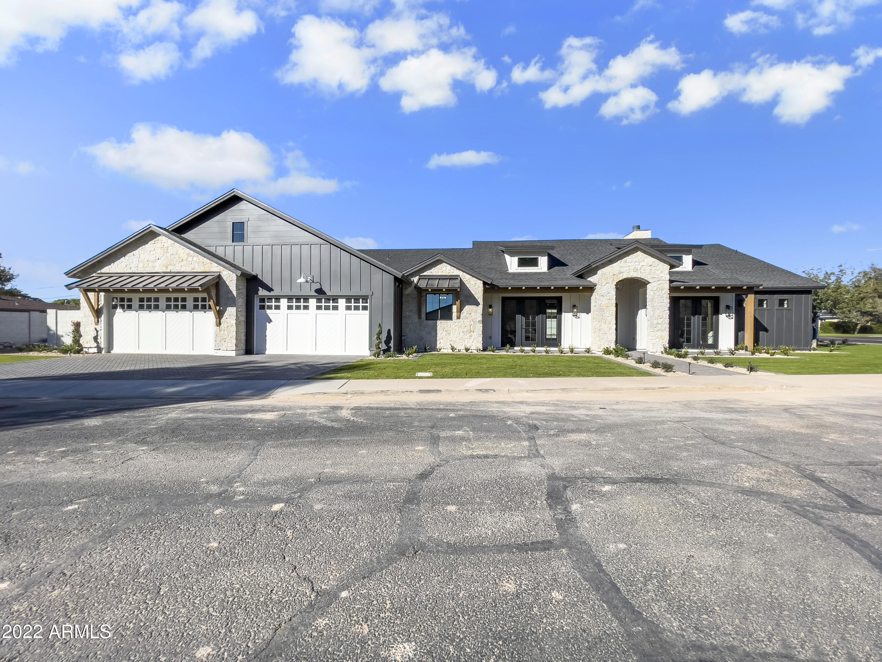Gorgeous, Arcadia Lite Modern Farmhouse.  Oversized lot (16,200 SF), rare 4 car garage, Camelback view off backyard, wood and tile flooring throughout, vaulted ceiling in kitchen/great room.  Home has a fully detailed Butler's Pantry with sink, wine fridge, ice maker, dishwasher, micro, and fridge.  All 3 auxillary bedrooms have their own bathrooms and flood into a secondary gathering room/teen room.  The private backyard has a massive covered patio, custom pool with water feature, heated spa, built-in grill, outdoor fridge and sink.  East side of the yard features a private arizona garden with a stone patio sitting area.