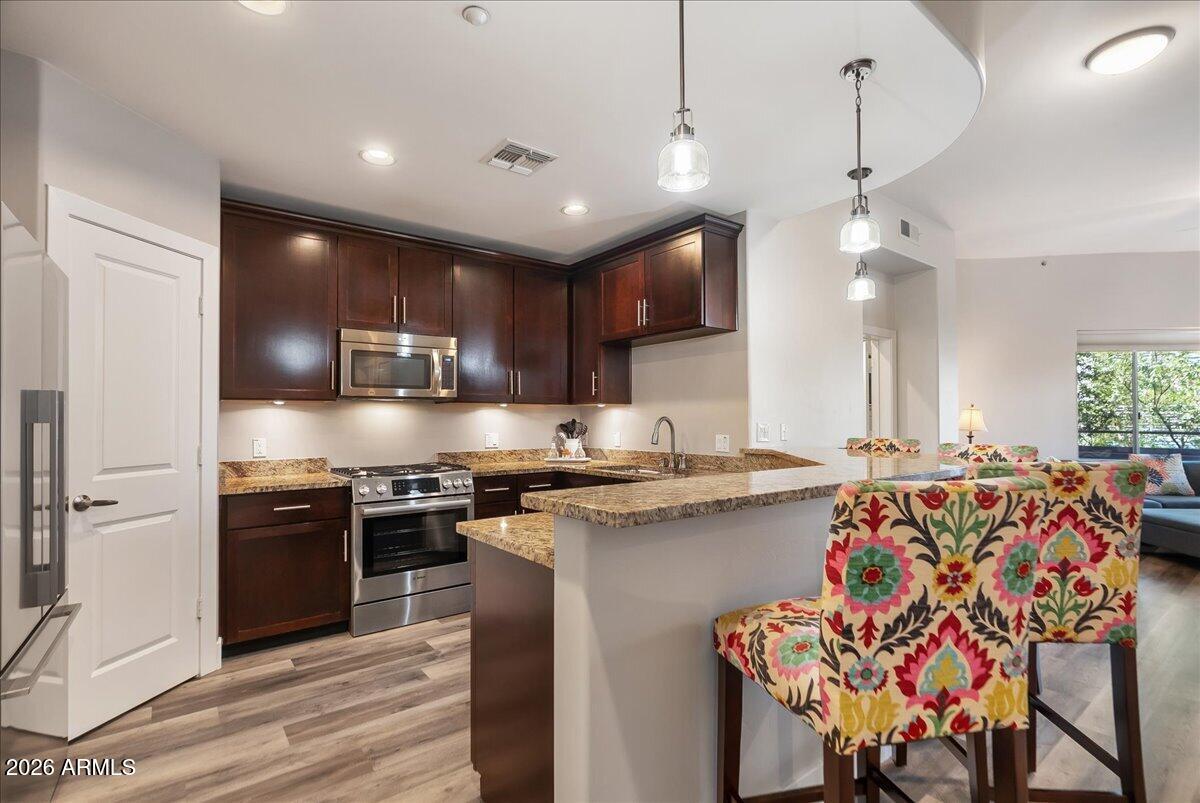 Luxury modern Resort living on the North Shore of Tempe Town Lake. ~Owners want it SOLD! ~Ideally suited for professionals &  ASU students. The 2 bedroom split floorpan bracket the spacious & updated kitchen; w/ a pantry. The counter with colorful bar stools spills into the great room. Then step outside from the wall of windows onto your private balcony, replete with a fireplace & there's also balcony access from your Primary BR that's En Suite + ample closeting. Many details including a laundry room with washer, dryer ~ many other upgrades found in this penthouse-like property. Underground parking is highly desirable as are the workout facilities, on property pool and high security entrance in this luxe address. Furnishings available under separate bill of sale so it can easily turnkey!