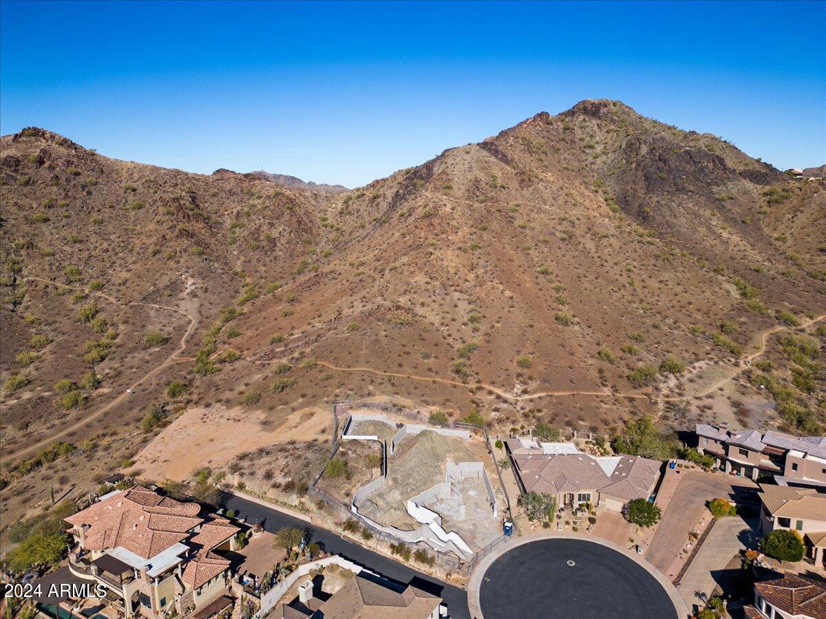Prime Investment & Build Opportunity in Phoenix Mountain Preserve Estates. Rarely available, this fully ready-to-build lot offers sweeping downtown skyline and Piestewa Peak views within the exclusive 13-lot gated enclave of Phoenix Mountain Preserve Estates.
For builders and investors, this property is truly shovel-ready: plans for a 7,691 sq. ft. luxury residence, Site prep, grading, and retention work already started, cutting years off typical hillside review and approval timelines. The location is unmatched—direct Preserve trail access, under a half mile to the 51 freeway, and just minutes to Downtown Phoenix, Biltmore, and Central Corridor amenities. This area's prestige, privacy, and scarcity of available lots make it a high-demand, low-supply opportunity with significant upside.