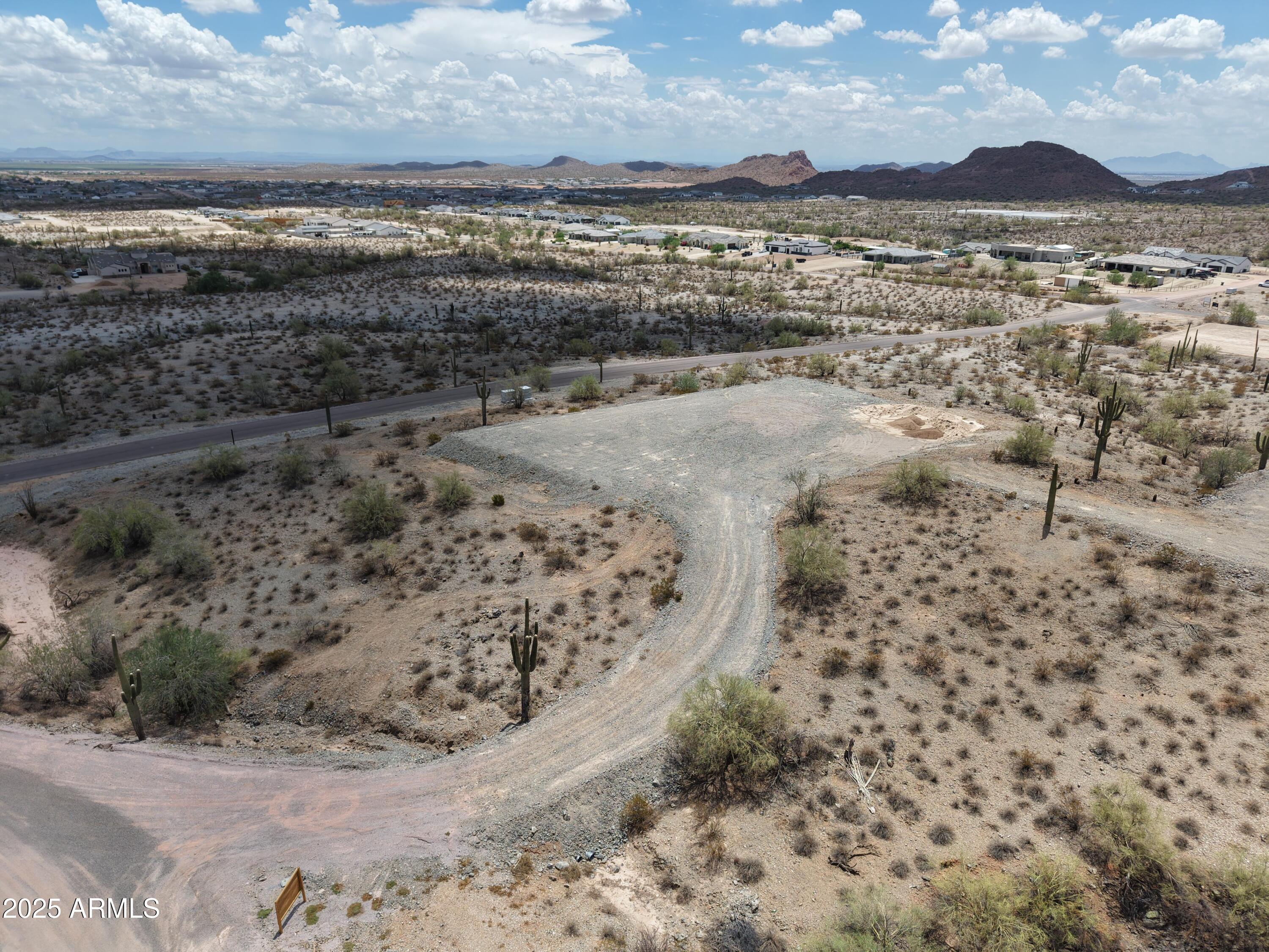 Build your dream home on this 2.67-acre hillside lot in San Tan Valley! Elevated terrain offers stunning views and added privacy. Surrounded by million-dollar custom homes, this level and build-ready parcel has water and electric on-site, no HOA, and plenty of space for your ideal estate, horses, or toys. Enjoy peaceful desert living with quick access to shopping, schools, and Queen Creek amenities. Zoned GR—perfect for a custom site-built home in a growing luxury home corridor. Seller financing available with attractive terms.