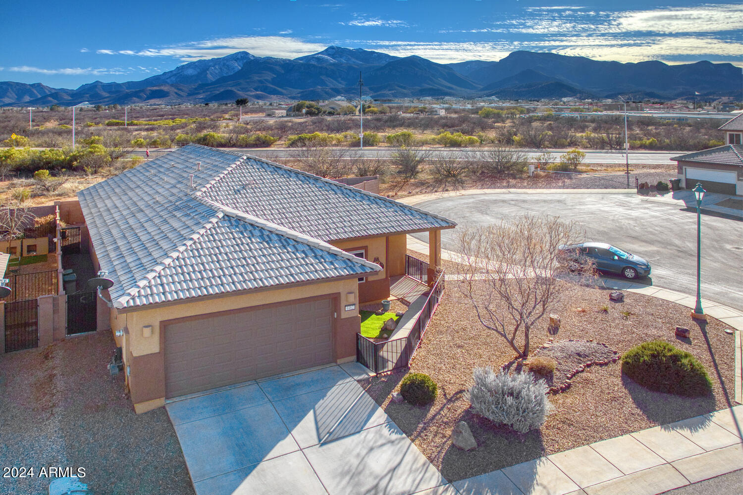 Discover the pinnacle of luxury living in this 3BR, 2BA haven on a tranquil cul-de-sac's end. The split floorplan, ceramic tile, and open design redefine sophistication. A chef's dream, the kitchen boasts stainless steel appliances and a chic single-basin sink. The master suite offers panoramic views of the Huachuca Mountains, with a spa-like bath featuring dual sinks and a vast walk-in shower. Ceiling fans and sensored lighting adorn every room. Bulldog Security Screens add both protection and a unique aesthetic. Unmatched in elegance, this home pairs meticulous design with unrivaled mountain views—your search for the perfect abode ends here!