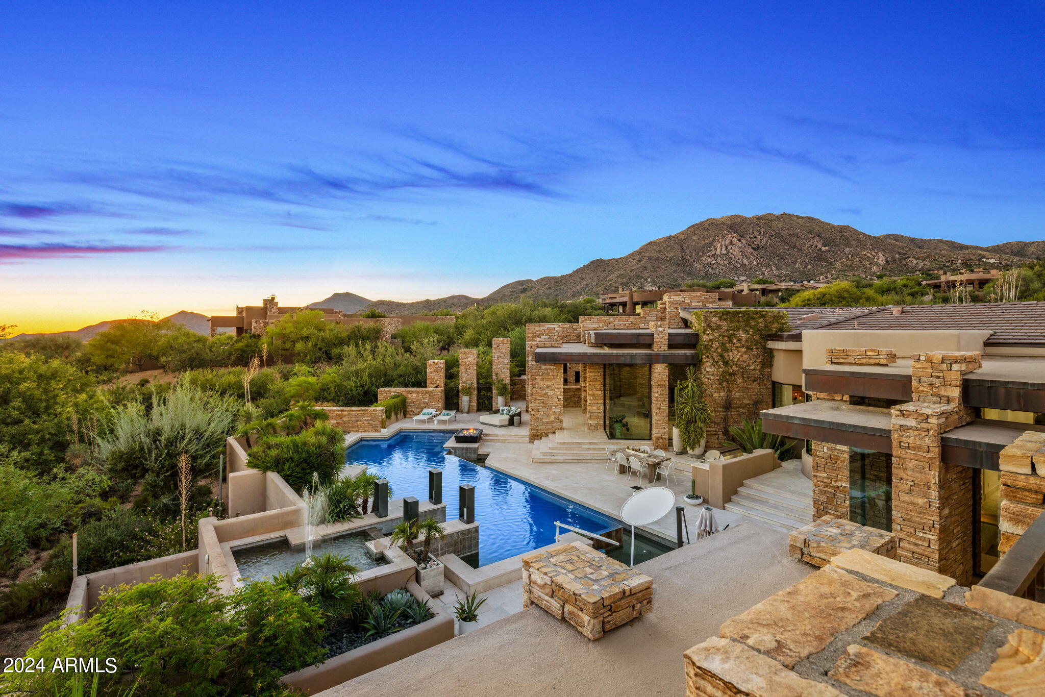 Experience the epitome of luxury living in this exquisite Desert Mountain home designed by James Hahn and constructed by Robert Byrd, offered with a rare Golf Membership. The Great Room is an entertainer's dream with a wet bar and wine bay to compliment the open space. The well appointed and thoughtfully designed kitchen offers upgraded appliances and plenty of storage. A private and inviting owner's suite includes a spa like ensuite, 2 walk-in closets, fitness studio and private patio with a heated spa. An abundance of natural light fills the home by day and cool evenings draw you to the outdoor living spaces which include Al Fresco dining, a heated pool, spa and an elevated view deck to capture sunset, mountain and city light views or take in your favorite game on the retractable TV.