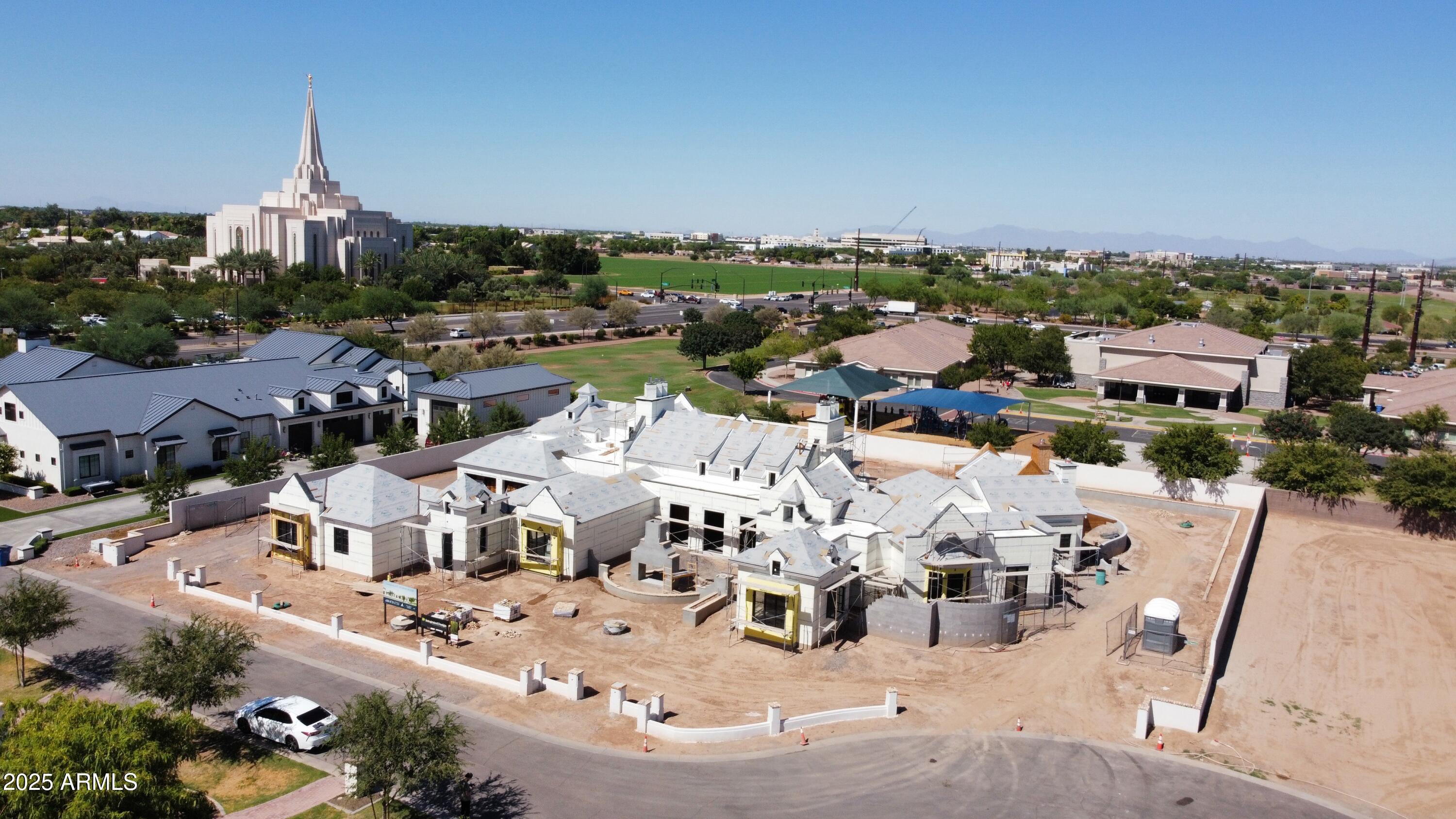 Available for pre-sale: A one-of-a-kind architectural masterpiece, this ultra-luxury Gilbert estate blends classic European influences with refined contemporary design, harmonizing old-world charm with modern sophistication. Sculpted lines and resort-style grounds frame breathtaking views and thoughtful indoor-outdoor living. Outdoor amenities include multiple gathering spaces, a sport court, a garden-framed pool, and a covered View Pavilion with kitchen and dining areas. The Primary Wing offers a private garden, office, and fitness room, while the basement reveals a cinematic theater, lounge, and shaded courtyard. Over 2,000 sq. ft. of climate-controlled garage space and a charming guest house complete this exceptional estate—a perfect balance of artistry and craftsmanship.