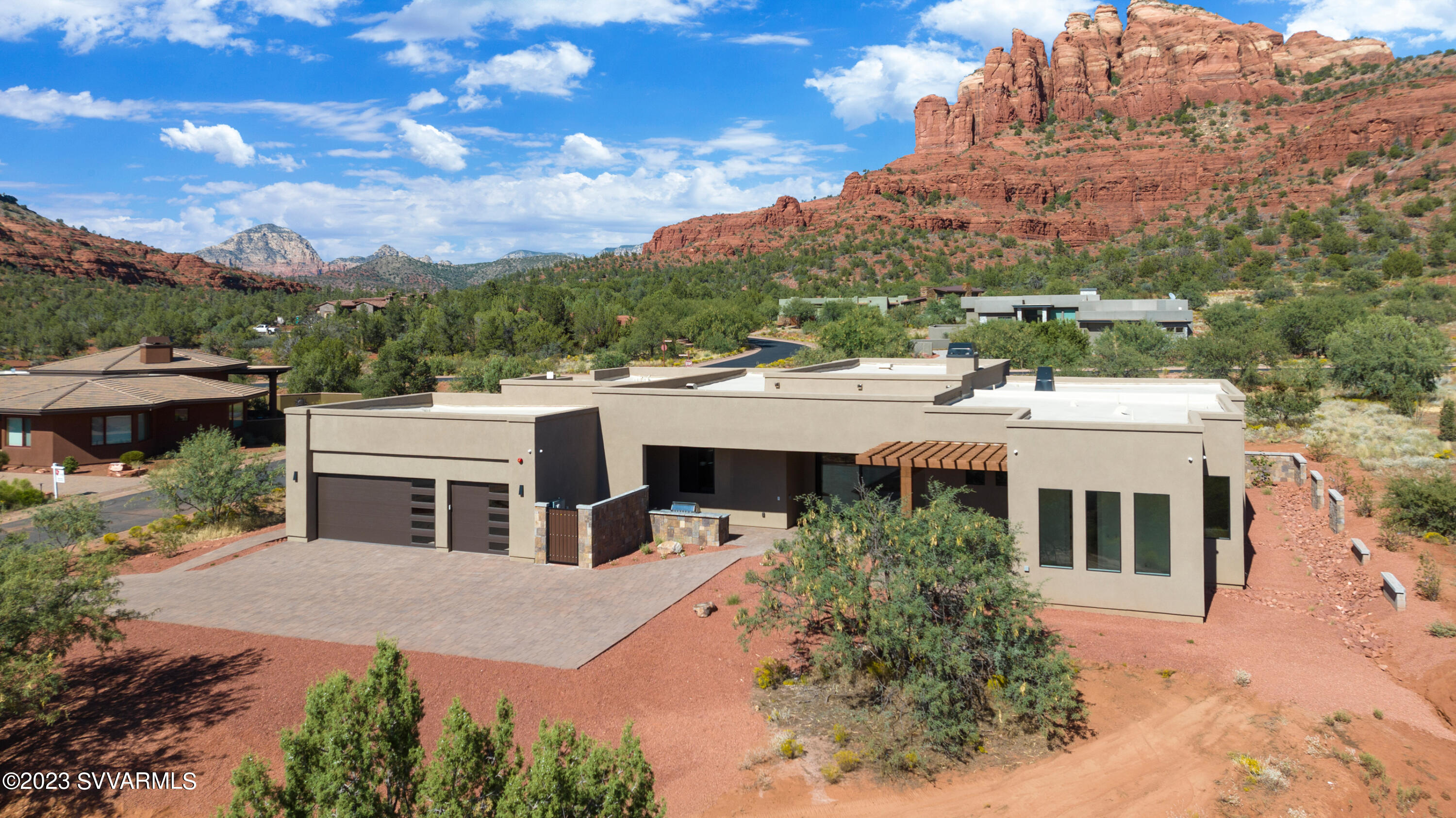 Introducing a STUNNING, NEW LUXURY home offering drop dead gorgeous Red Rock views of Cathedral Rock in the exclusive CR Ranch gated community. Welcome to a truly remarkable residence that effortlessly combines modern design with luxurious details. This single level split floor plan features four bedrooms each with its own ensuite bath, plus an office/yoga/meditation room. The interior showcases beautiful European white oak flooring, accompanied by captivating T & G 14' ceilings with floor to ceiling walls of premier windows to capture the red rock views! This extravagant kitchen offers top of the line appliances including Sub Zero refrigerator and Wolf range. Stunning two toned white lacquer and white rift oak custom cabinetry with spacious Quartz island and modern upscale lighting fixtures. The master suite is special with a sleek contemporary fireplace embellished with fluted wood panel accents and windows to bring in the Red Rocks. Prepare to be amazed by this stunning Primary bathroom with elegantly designed space featuring Mother of Pearl tiled shower with dual heads, body sprays and rain shower and separate soaking tub. Opulent custom walk in closet thoughtfully designed to keep everything organized. Extra room off the master for many purposes. Serviced by two tankless hot water heaters, water filtration system and full house speakers and security system. Your outdoor living space with front and back pavered patios and built in BBQ will bring entertaining to the next level. Schedule your showing today!