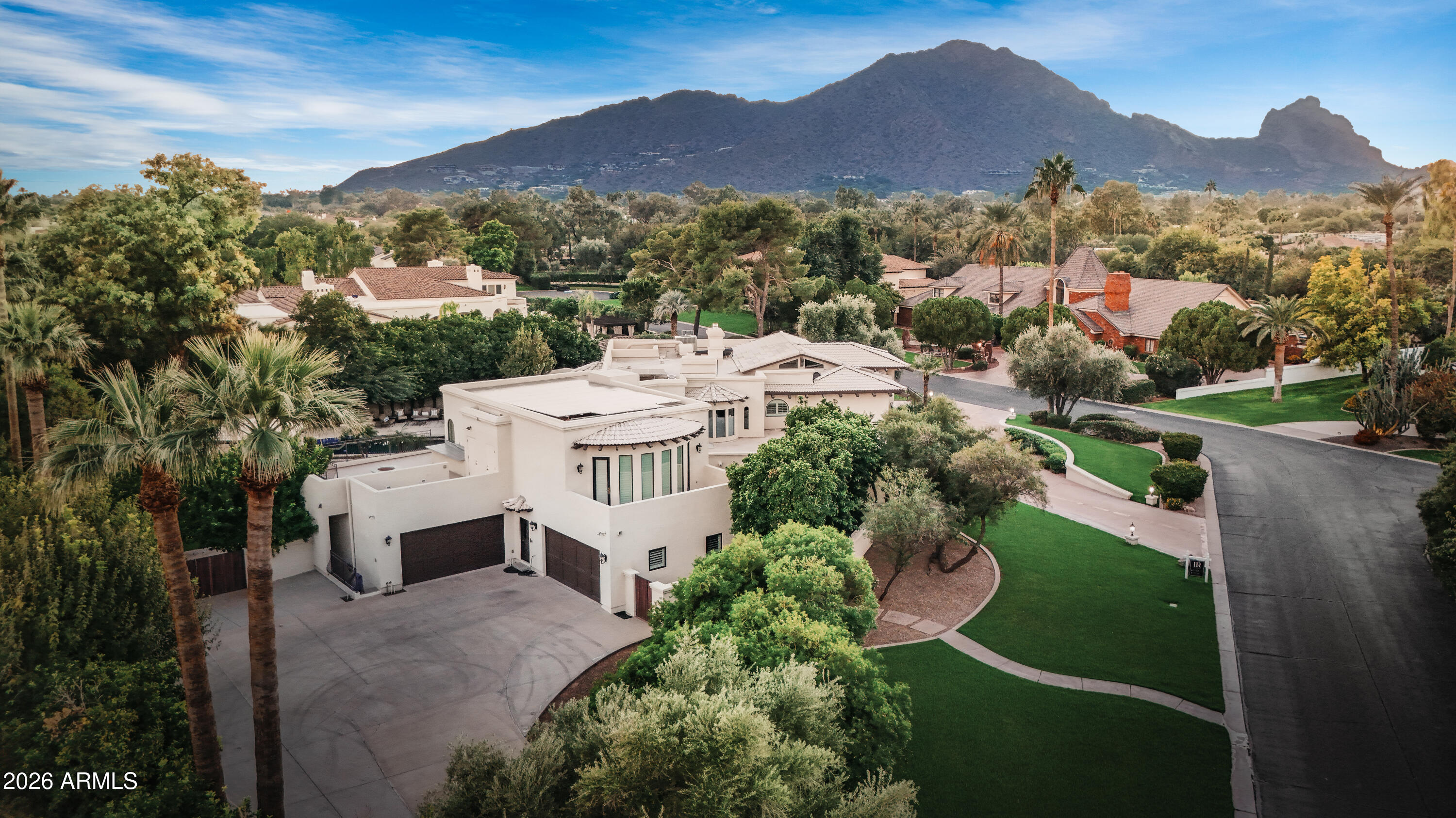Nestled within the exclusive La Place enclave, this sprawling estate spans 1.04 acres and embodies refined luxury and timeless sophistication. Offering 11,470 square feet of  living space, the residence features six ensuite bedrooms and eleven baths curated for both grand entertaining and serene private living.

A dramatic entry welcomes you with soaring ceilings and seamless indoor-outdoor living, while expansive terraces frame breathtaking views of Camelback and Mummy Mountains. The chef's kitchen, complete with a dedicated catering kitchen, opens effortlessly to resort-style grounds featuring a shimmering pool, spa, fire-pit lounge, and lush mature landscaping including numerous citrus and fruit trees.

The fully finished lower level is designed for elevated entertaining, showcasing a private home theatre, 800+ bottle wine cellar, and recording/podcast studio, with elevator access to every level of the home. The private primary wing serves as a true retreat, offering dual spa-inspired baths, oversized walk-in closets, a fitness room, sauna, cozy fireplace, and two secluded outdoor terraces.

Complete with a 5-car garage, motorcycle lift with underground storage, and an address synonymous with prestige, this Paradise Valley estate presents an exceptional opportunity to own a truly one-of-a-kind residence. Ideally situated just minutes from Mountain Shadows, The Global Ambassador, Sanctuary Camelback Mountain, world-class dining, luxury shopping, premier golf, and scenic hiking trails, the home offers an unparalleled blend of privacy, sophistication, and convenience in one of Arizona's most sought-after locations.