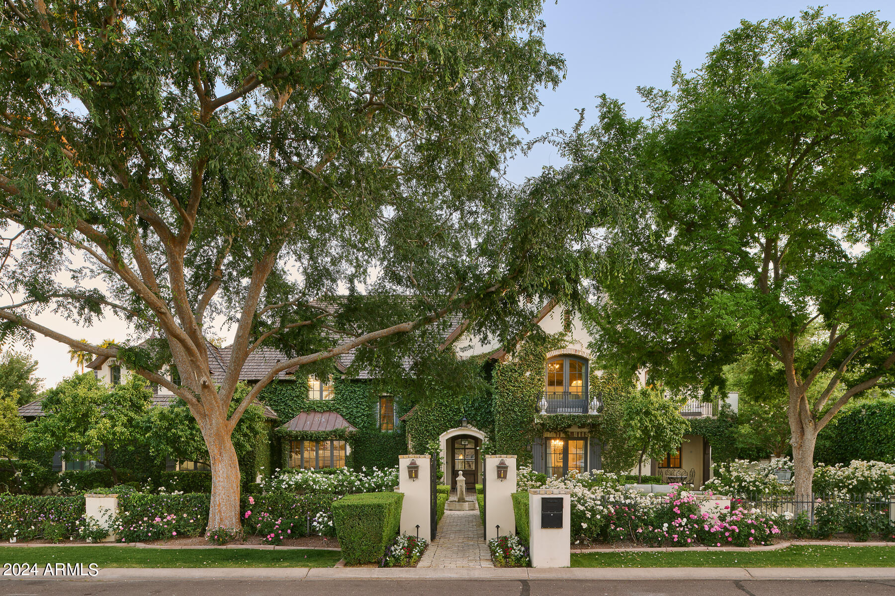 Incomparable quality, stunning design detail, and idyllic location in the heart of Arcadia! This French Country estate was completely updated inside and out in 2023. Included inside are 4 beds, 4 baths, 3 half baths. The meticulous landscape is a show stopper and welcomes you in, featuring multiple fireplace and fire pit details in the front and back yards. Inside you're welcomed to a great room and kitchen with Bi fold doors that open up to the great room and game room making it a true entertainer's dream, with the perfect indoor/outdoor living setup. A spacious great room with stunning architectural beam details in the soaring ceiling opens to a top of the line gourmet kitchen with two large islands, reclaimed beam details, custom cabinetry and walk-in butler's pantry w/ secondary ovens and refrigerator/freezer. The heart of the home may just be the game room with a full custom bar, specially designed wall paneling and four 83 inch televisions making one large screen that can play one or up to four shows/movies. Included in the downstairs is three half baths, an office with views, and convenient elevator access. Impressively designed formal dining room with a beautifully bricked ceiling and fireplace and custom french open touch cabinetry that was custom painted. New light fixtures throughout showcase this home's unique and stunning French touches and design. Technology features include a security system and a brand new AV system. Magnificent primary bedroom with charming vaulted ceiling details with unobstructed Camelback Mountain views! Custom marble flooring and steam shower details, private wet bar, oversized walk in closet and beautiful soaking tub! A state of the art home gym. A wonderful kids wing with ensuite bedrooms, walk in closets and separate kid's family room. The backyard includes misters and heaters for all seasons of the year, an entertainer's outdoor kitchen with a 65 inch grill, pizza oven, warming and storage drawers, beverage center, and refrigerator, under a gorgeous trellis. A pickleball court, garden, RV gate, and a putting & chipping green as well. Enjoy all Arizona has to offer under the beautiful Ramada with a pool bath and full storage closet with custom cabinets, looking out to the french inspired garden pool and spa. This home is privately located on a quiet cul-de-sac street on a corner lot. This home is truly one of a kind inside and out!