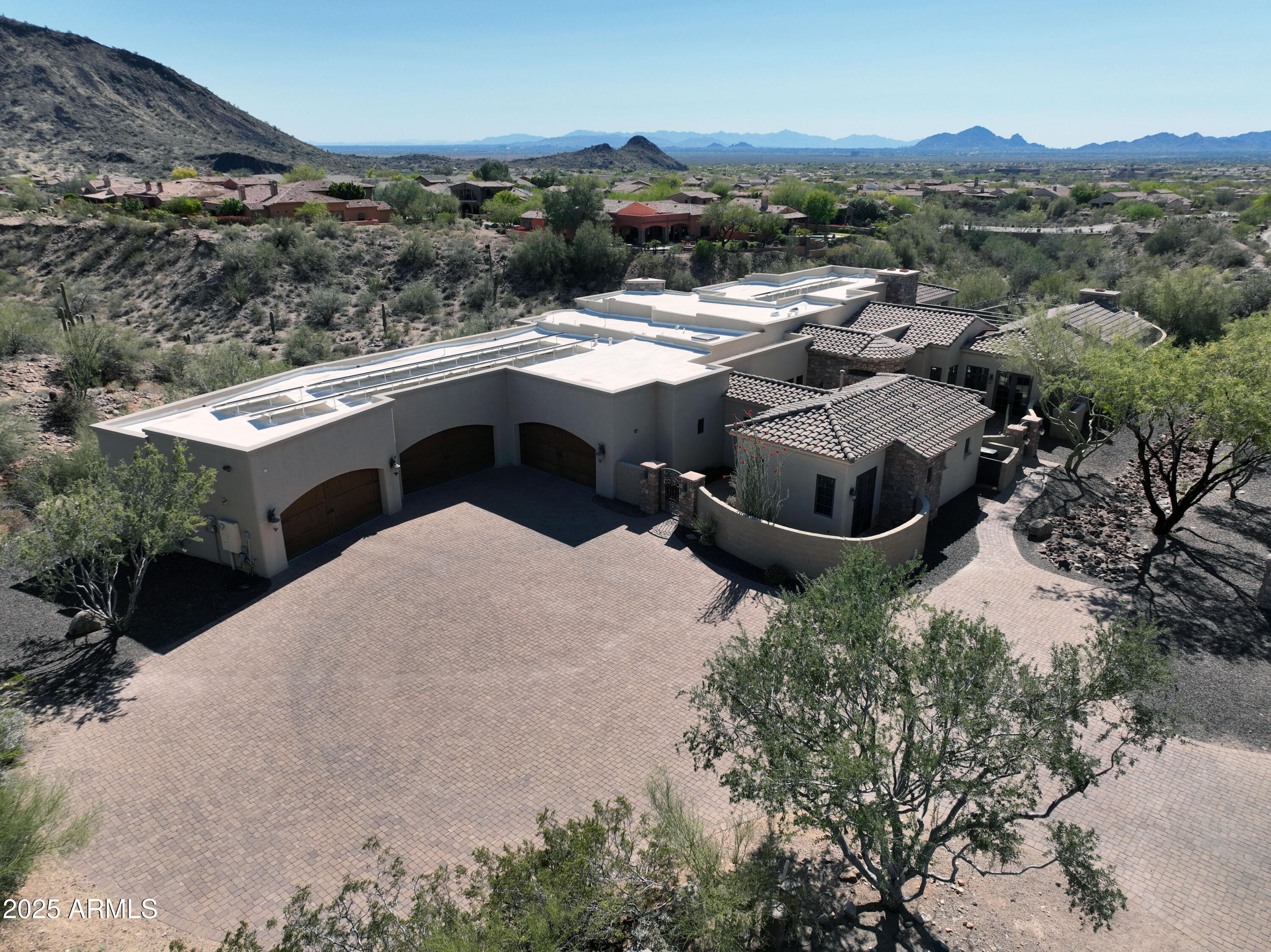 Very private! Just down the road from Ancala, a Totally custom home w/ 7 CAR GARAGE!  A Totally Custom Estate with 5 Beds, 5,178 SF, and a Rare 7-Car Garage. Perched between the Mountains with Stunning Views of the Valley, City Lights, and Sunsets. Designed by architect Daniel Eastburn and built in 2008 under the Scottsdale Green Building Program. Features include a Viking Chef's Kitchen with 10-ft Granite Island, Full Bar, Game Room, Private Office, and a Luxurious Primary Suite with Spa-Style Shower. The Resort-Style Backyard offers a Lap Pool and Expansive Covered Patio with Built-in Viking Grill, Granite Counters, Beverage Fridge, and 2-Burner Cooktop. Designed for seamless Indoor-Outdoor Living and Year-Round Entertaining. Ideal for Multigenerational Living, Remote Work, and Entertai