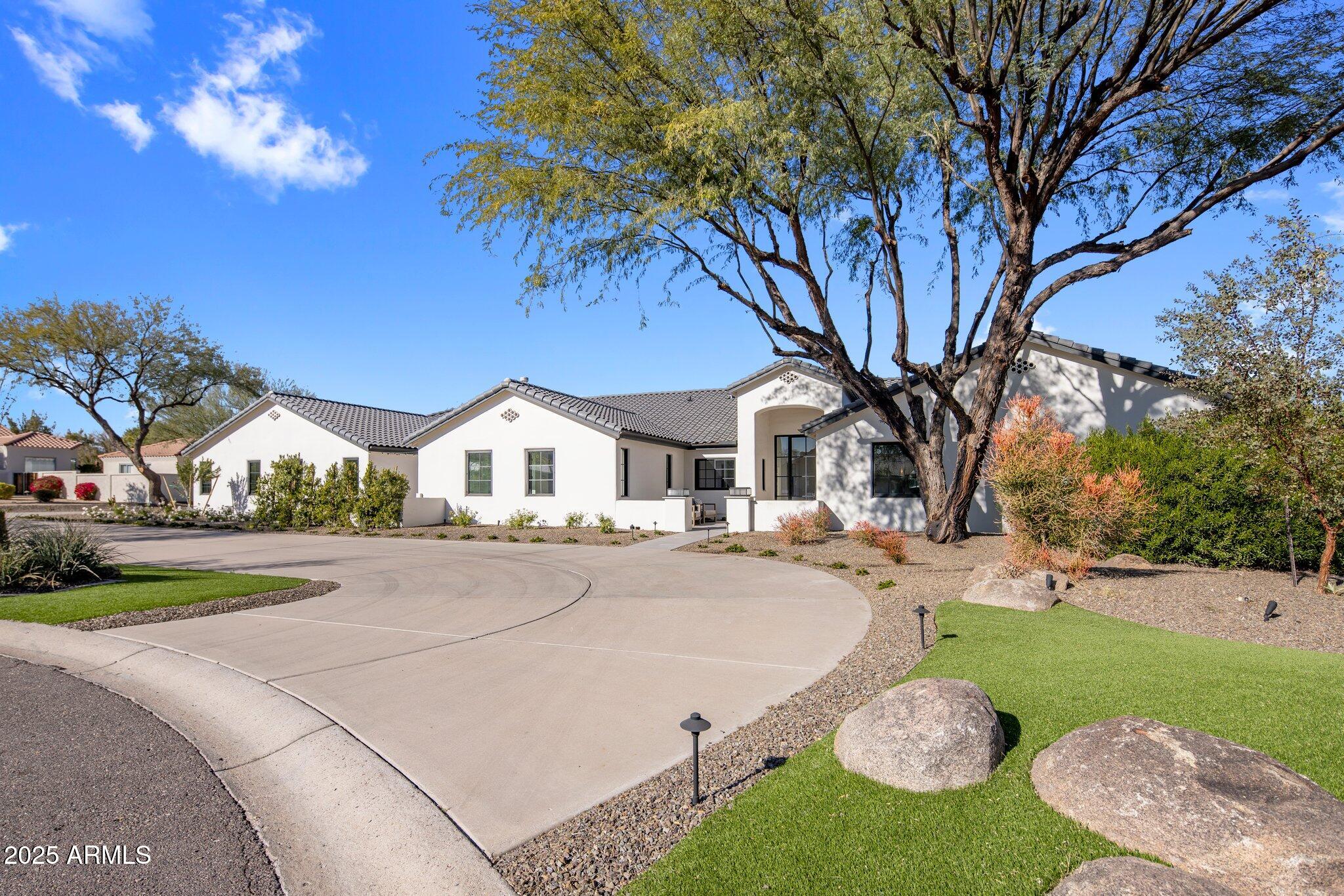 Experience the pinnacle of luxury living in the heart of Paradise Valley! This extensively renovated 2024 masterpiece feels like a new build, offering a fresh, modern design and impeccable craftsmanship. Nestled on a pristine acre with breathtaking Mummy Mountain views, this 5-bedroom, 5.5-bath home boasts a split floor plan, a dedicated office, and an exercise room. The gourmet kitchen features top-of-the-line appliances, a butler's pantry, and a stunning wine wall. Indoor-outdoor living comes to life with expansive patios, a brand-new pool, and resort-style landscaping. A true oasis, this home is perfect for entertaining or serene relaxation.
