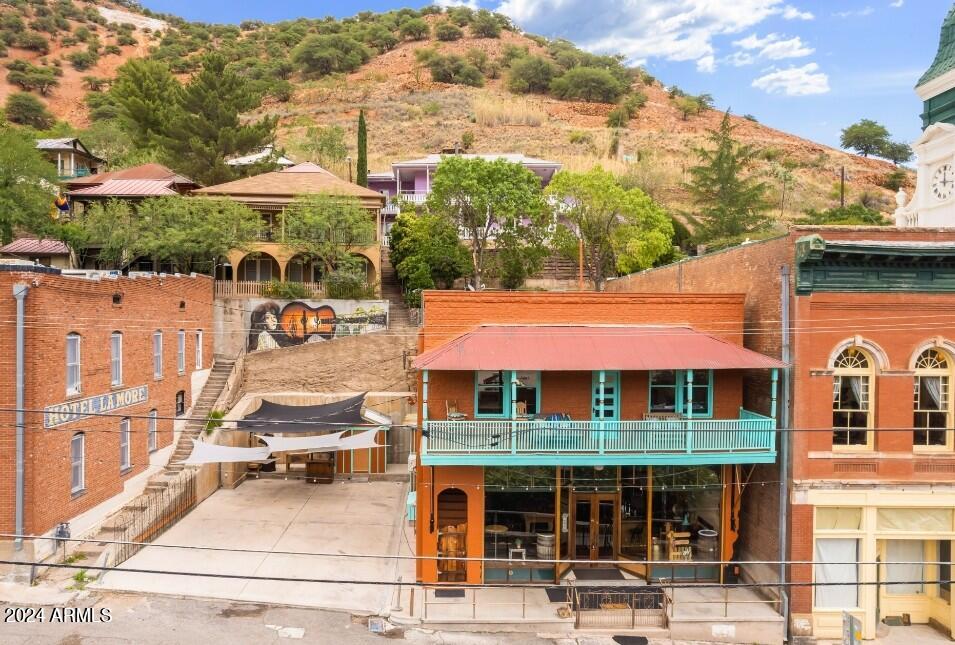 Truly Unique Old Bisbee Property- 3 Bedroom/5 Bath, 3,712 sq ft (including heated/cooled finished basement) with dedicated 2,000 sq ft PARKING LOT. Formerly Copper City Saloon and Hot Licks Saloon, now zoned Residential, with fully intact bar, fully furnished (complete with pool table), retrofitted to serve as a residential kitchen. Finished Basement serves as a Primary Bedroom with Jacuzzi, and 2 additional bathrooms, and separate Laundry Room.
Second Floor currently rented as Airbnb- with two separate units, vast Great Room with full Kitchen, 14' ceilings, hardwood floors, Covered Deck with great views of Downtown Old Bisbee and surrounding hillsides.
Includes 2 Parcels: 103-62-312 and 103-62-313.