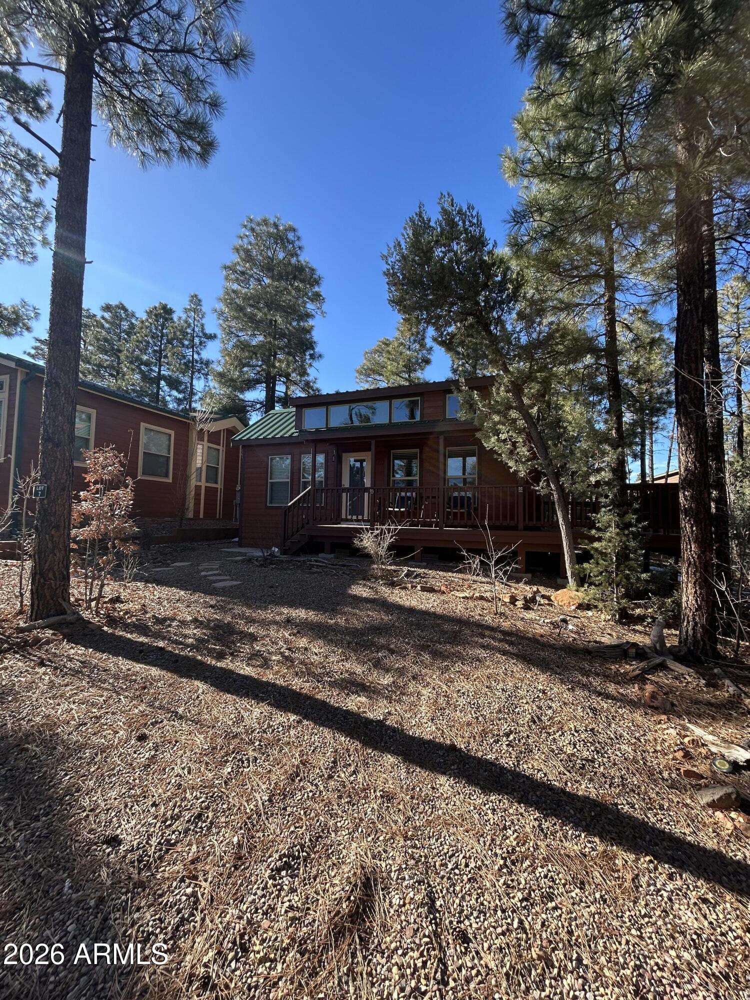 Sharp almost knew tiny home that's not so tiny has three bedroom spaces. One is a loft that a couple people can sleep in another is a room with a couple bunks and then you have a standard bedroom so plenty of room for you and your guest as they come up to enjoy the beautiful woods of northern Arizona easy to take care of space and maintain does have a convection microwave so it will cook just like a normal oven. You can cook the pizza and the chicken and all the same things you would cook in a normal oven just not taking up the space that formal oven wood cooktop for Other cooking beautiful decks to barbecue and entertaining on in the beautiful historic town of Showlow seller may carry so that is an option for those buyers needing that come and see your new home