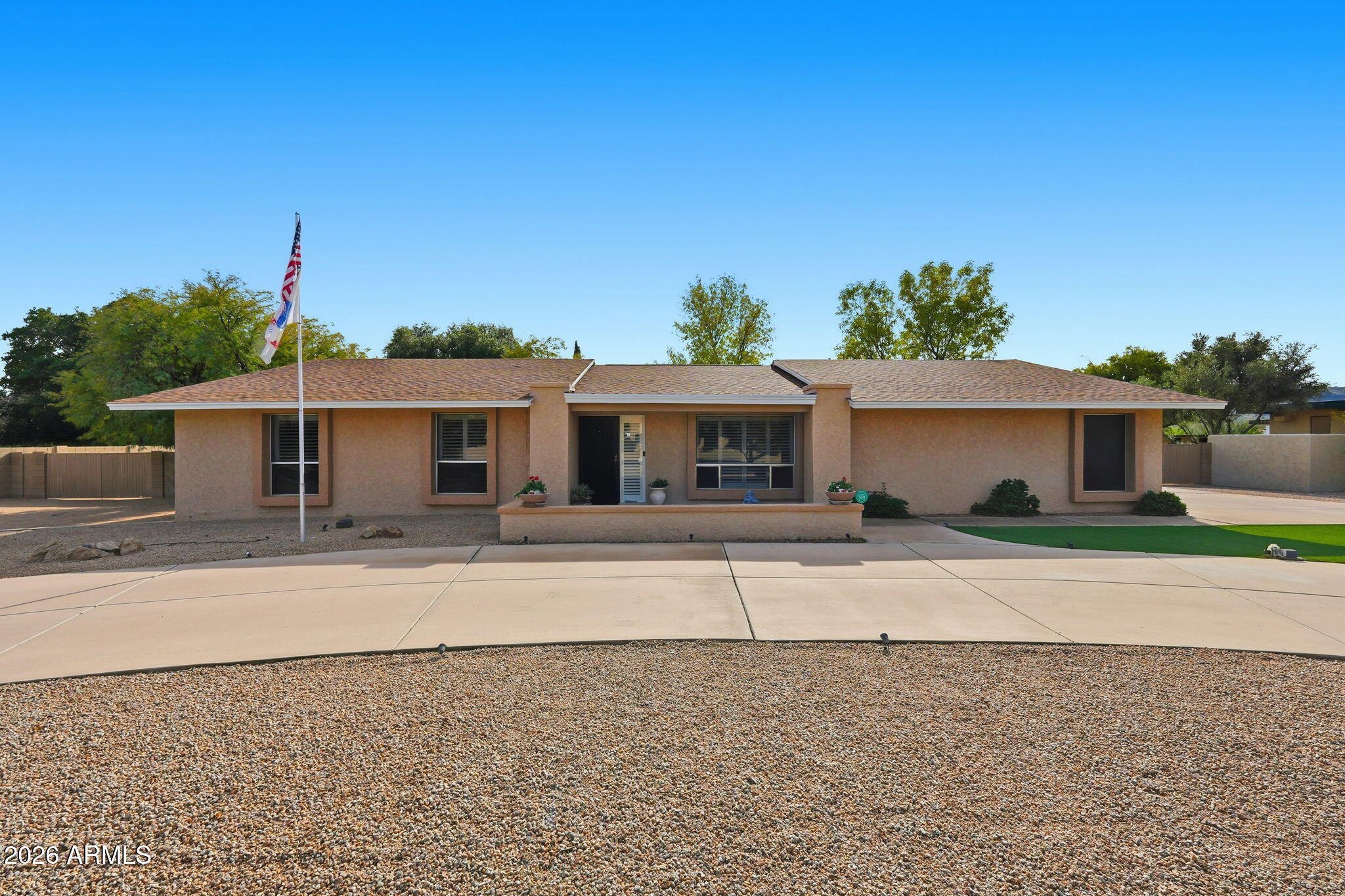Spacious single-level custom home in the desirable Glendale community of Saddleback Meadows - situated on a rare 1.1+ acre horse property lot with no HOA, mountain views & North/South exposure. Thoughtfully designed & meticulously maintained by the original owner, this residence features 6 bedrooms, 4 bathrooms, & 3,571 sq. ft. of total livable space with 5,168 sq. ft. under roof, delivering an impressive blend of scale, comfort, & functionality. The main residence showcases a new roof (2022), granite countertops, newer fixtures, & a thoughtful mix of carpet, tile, & wood flooring. The inviting family room & bar area are anchored by a wood burning masonry fireplace, creating an ideal space for gathering & entertaining. Additional highlights include plantation shutters, solar screens, a security screen door, and a central security system with cameras. The spacious primary suite offers a private sitting area, walk-in closet, & walk-in shower, while a notably large secondary bedroom (22.5' x 12') provides exceptional flexibility. Laundry room cabinetry is included, along with washer, dryer, & refrigerator. Enhancing the property is a fully separate guest house designed for privacy & comfort, complete with new HVAC (2025), roof (2025), & water heater (2025), fresh interior & exterior paint, travertine stone & carpet flooring, a full kitchen, living area, washer, refrigerator, security screen door, & a dedicated 2-car garage. Comfort is ensured year-round with three electric heat pumps (east unit 2011, west unit 2021, guest house 2025), central air with three new thermostats, & ceiling fans throughout. Parking & storage are abundant with a 2-car garage on the main home featuring epoxy floors, built-in cabinetry, & automatic garage doors, plus a full concrete 16' circular driveway, eight slab parking spaces, & two 12' RV gates with iron & wood construction. Outdoor living is equally impressive, offering a 592 sq. ft. covered patio, a 20' x 20' gazebo, iron fire pit, rear grass yard, & front desert landscaping with turf. Automatic irrigation systems serve both front & rear yards, with front trees on timer irrigation. The property is partially enclosed with block & chain-link fencing, providing privacy while maintaining openness.
Constructed with block and concrete foundation, masonry/stucco & wood framing, & blown cellulose insulation, this well-appointed estate presents a rare opportunity for single-level living with exceptional versatility, quality construction, & enduring appeal. Come check this home out today!