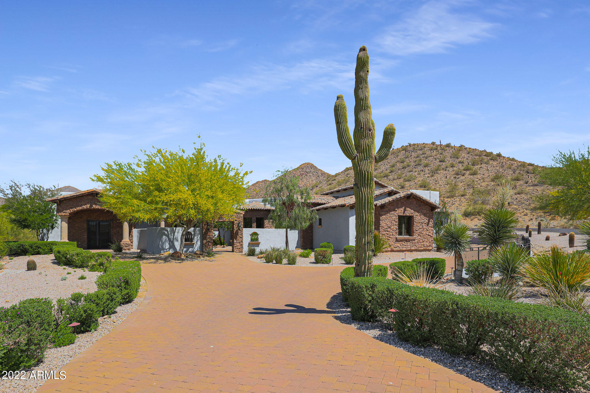 This custom home nestles at the base of the mountain which lends spectacular views and privacy! At the end of the cul-de-sac, this location is for the most discerning! Enter through the secure courtyard into the living room. Notice the beautiful fireplace. The open concept in the great room offers a luxurious kitchen with all of the desirable appliances including the double ovens. The large island is perfect for entertaining while the chef prepares the gourmet meals! Notice the 1000 bottle wine room as you mosey over to the movie theater. The floor plan is split and the master bedroom and bathroom are a show stopper! The two separate closets with islands, the large soaking tub, fabulous shower and separate vanities create a spa like experience.